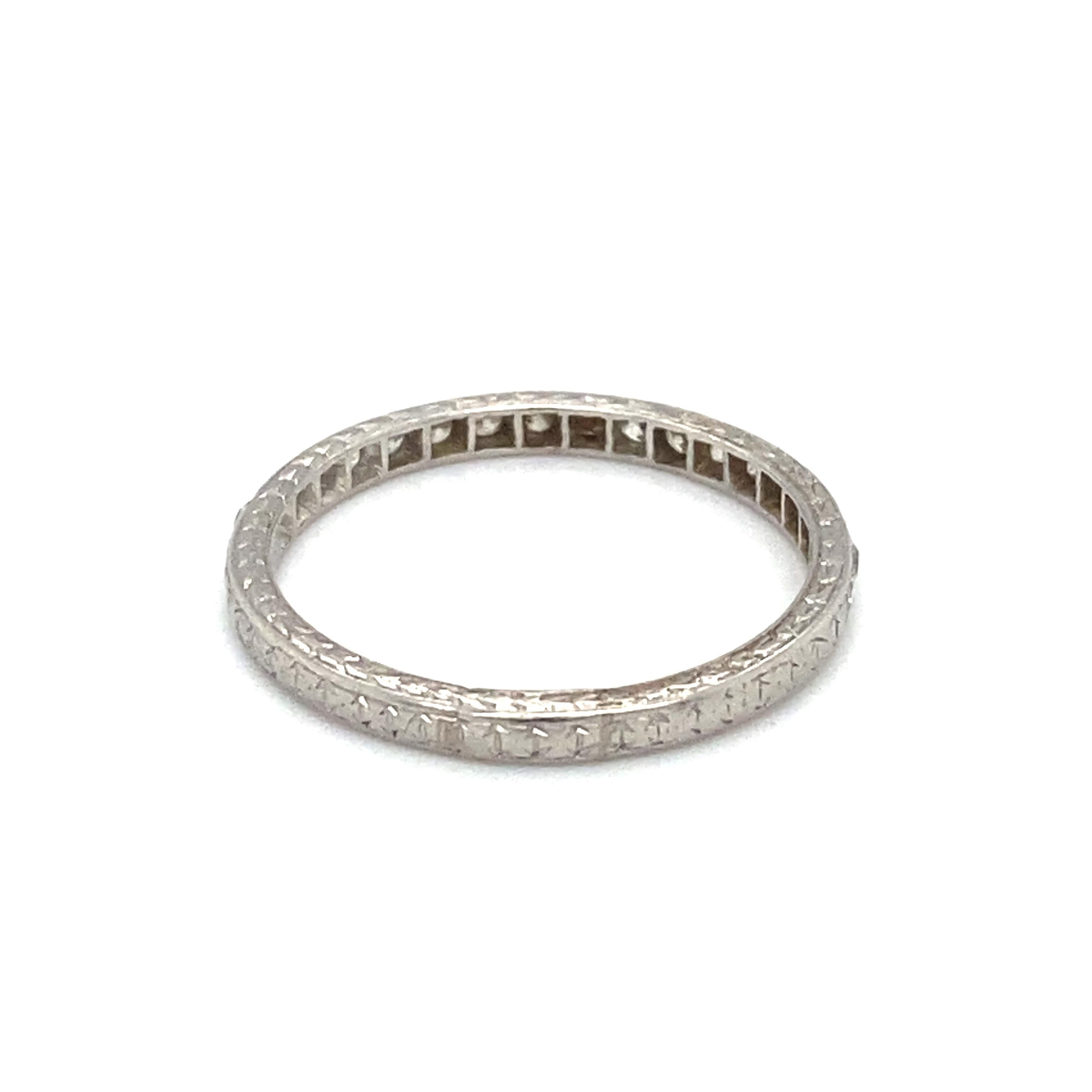 Item Details: This antique anniversary band has etching all around the band with diamond accents. The accent diamonds are bezel set. 

Circa: 1920s
Metal Type: 18 karat white gold
Weight: 2.2 grams
Size: US 7, resizable