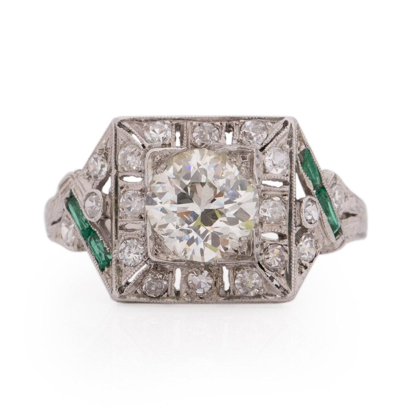 Fit for royalty, this exquisite Art Deco piece is a true masterpiece. With filigree detailing gracing the shanks and a magnificent 1.26 Ct center diamond, this ring is a testament to artistry. Every element harmonizes seamlessly to create a truly