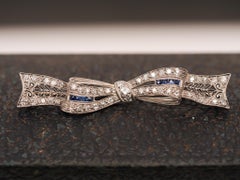 Circa 1920s Art Deco Platinum Sapphire and Diamond Ribbon Brooch