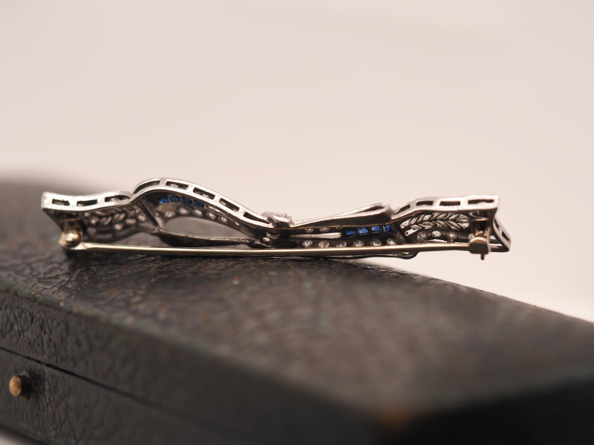 Circa 1920s Art Deco Platinum Sapphire and Diamond Ribbon Brooch In Good Condition For Sale In Hicksville, NY