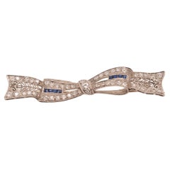 Circa 1920s Art Deco Platinum Sapphire and Diamond Ribbon Brooch