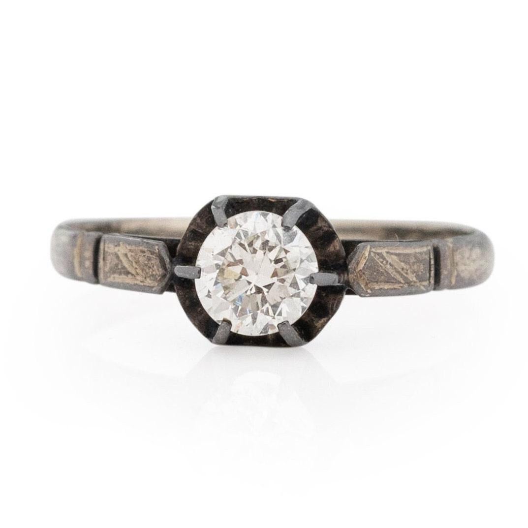 Here we have a great unique piece, this ring is crafted in sterling silver with a outstanding patina. This simple mount has very subtle details that compliment the overall look with ease. In the center held by six prongs is a .44Ct old European cut