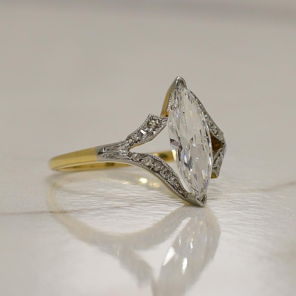 This killer beauty is not only a one of a kind piece but also one of the highest grade diamond that we have in our collection. The F colored showstopper is just over one carat. The yellow gold shank come up and splits to hold the marquise shape. At