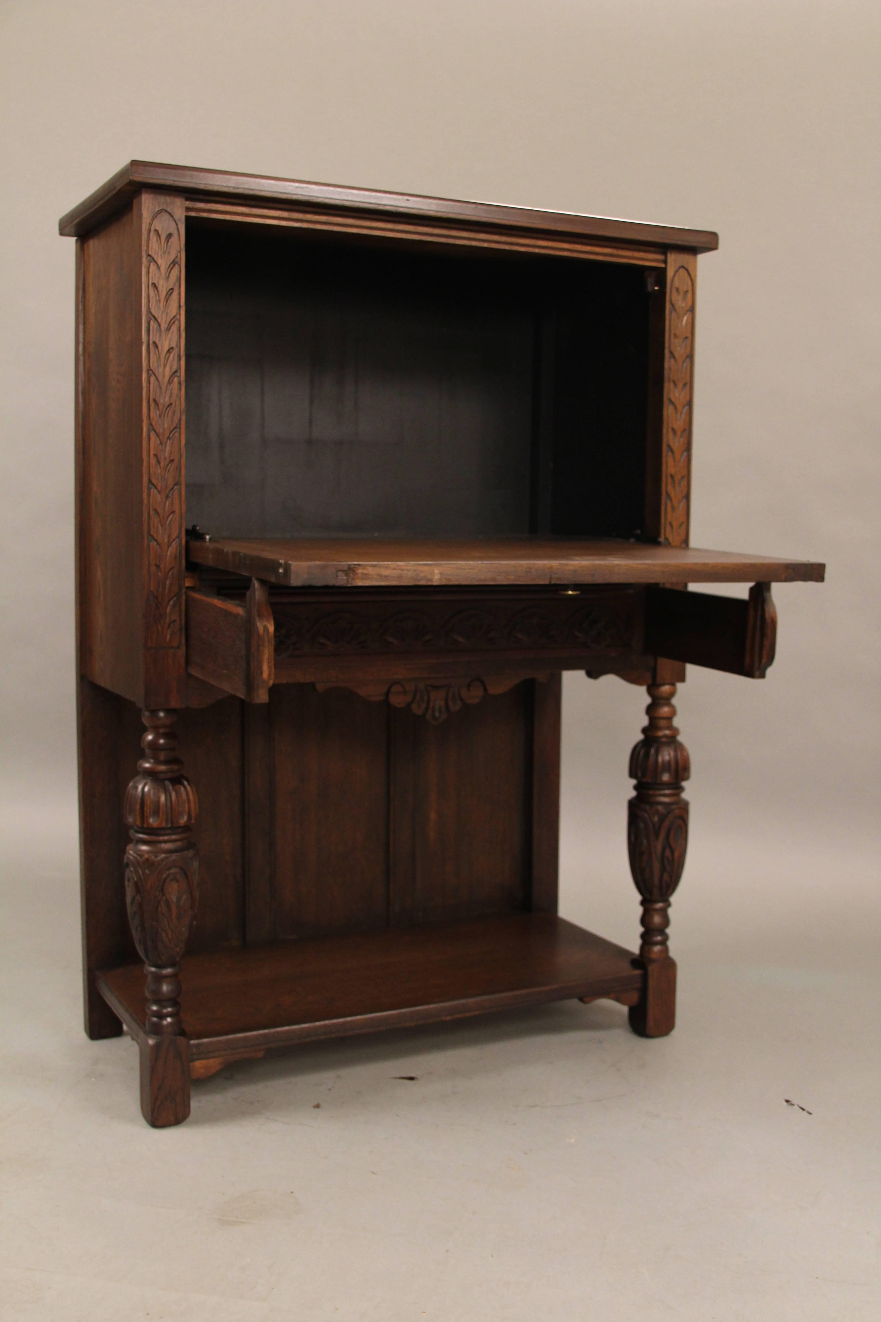Early 20th Century Carved Walnut Cabinet/ Writing Desk from the Angelus Furniture Co, circa 1920s