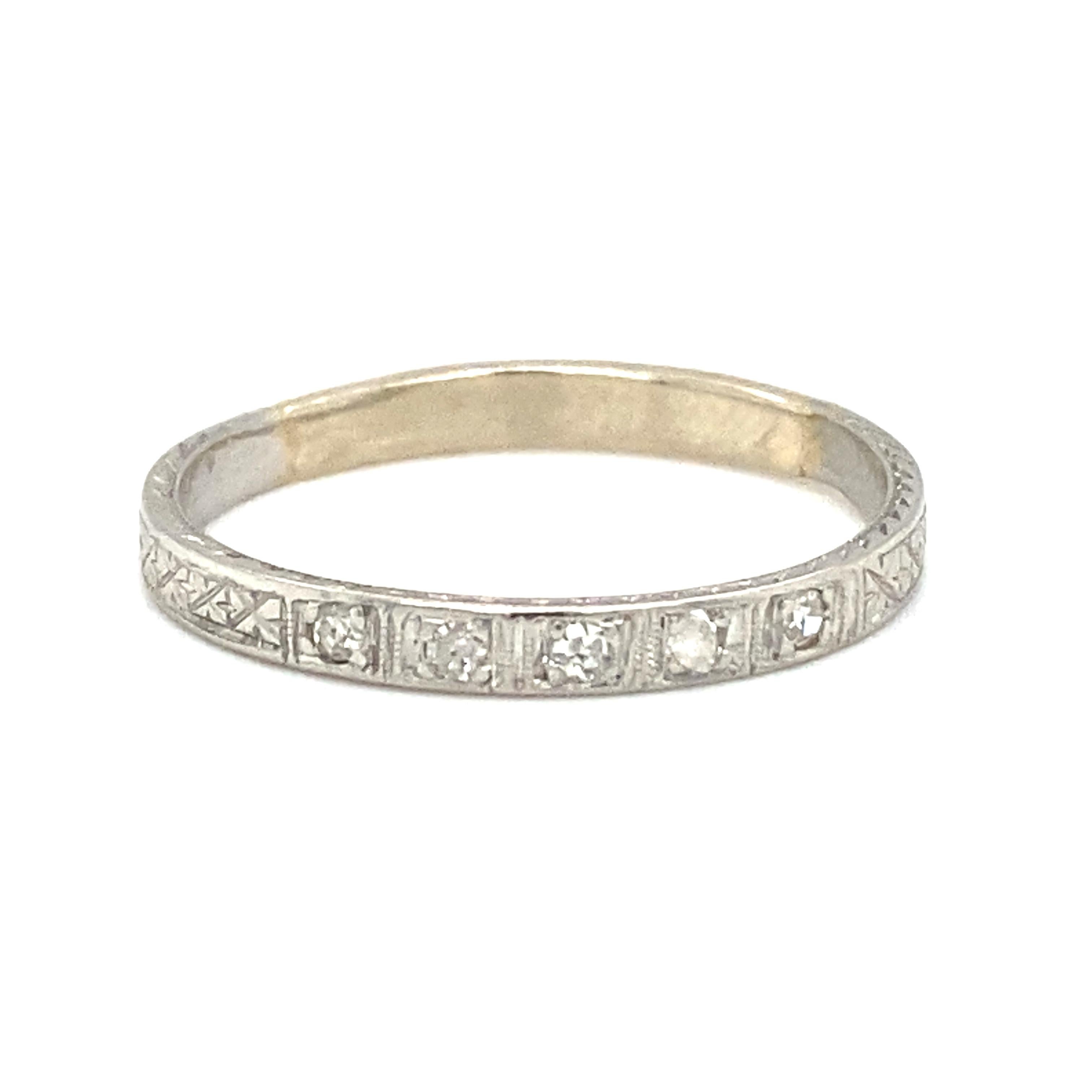 Item Details: This antique wedding band has five accent diamonds that are bezel set and is inscribed with the initials JEH. It has beautiful etching design work featured on the outer part of the ring as well as around the diamonds. 

Circa: