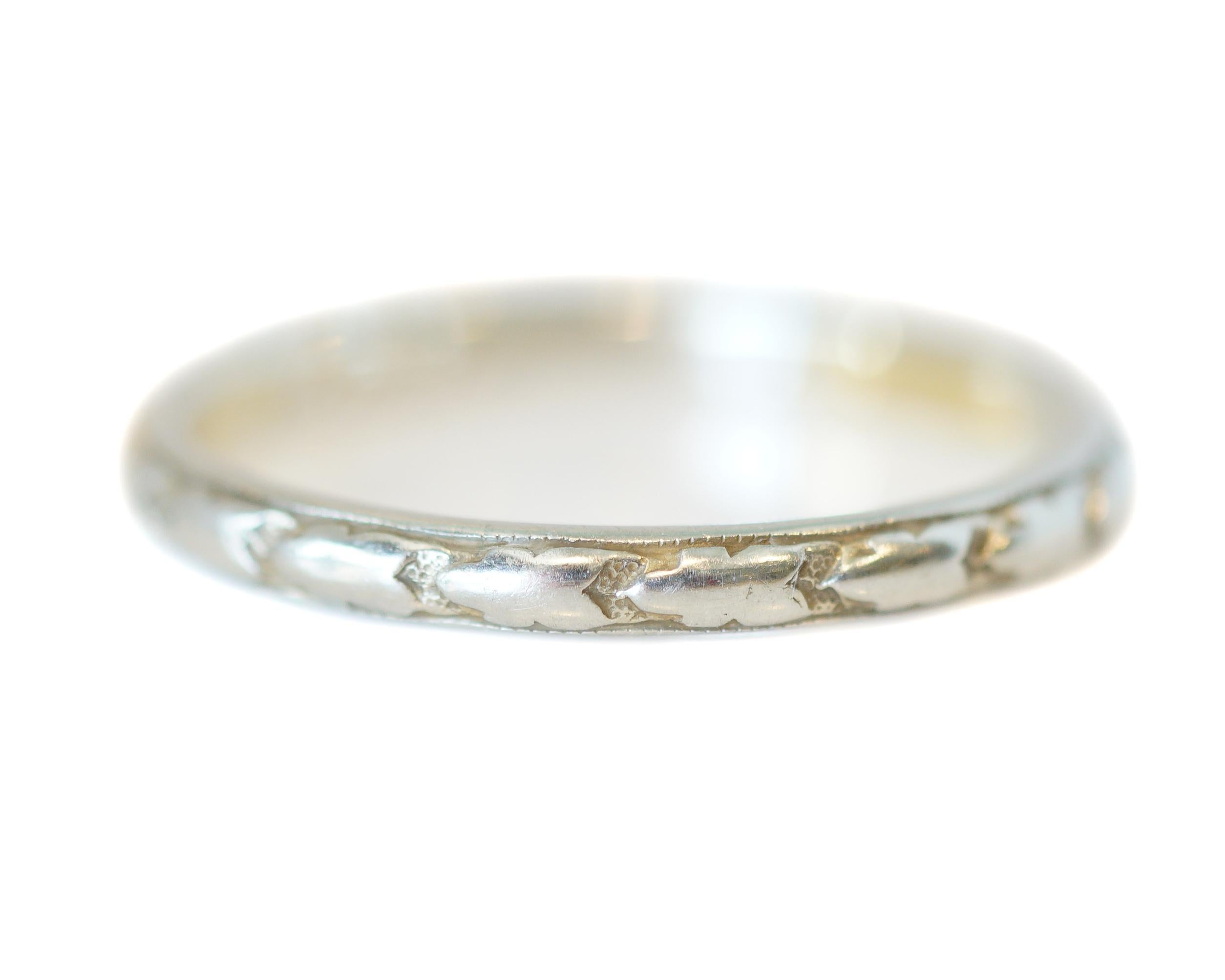 Beautiful and dainty wedding band from the 1920's. This band is from the Art Deco era and features a pretty arrow like pattern around the band. This band is 14k white gold and pairs well with engagement rings or could also be worn alone. A wonderful