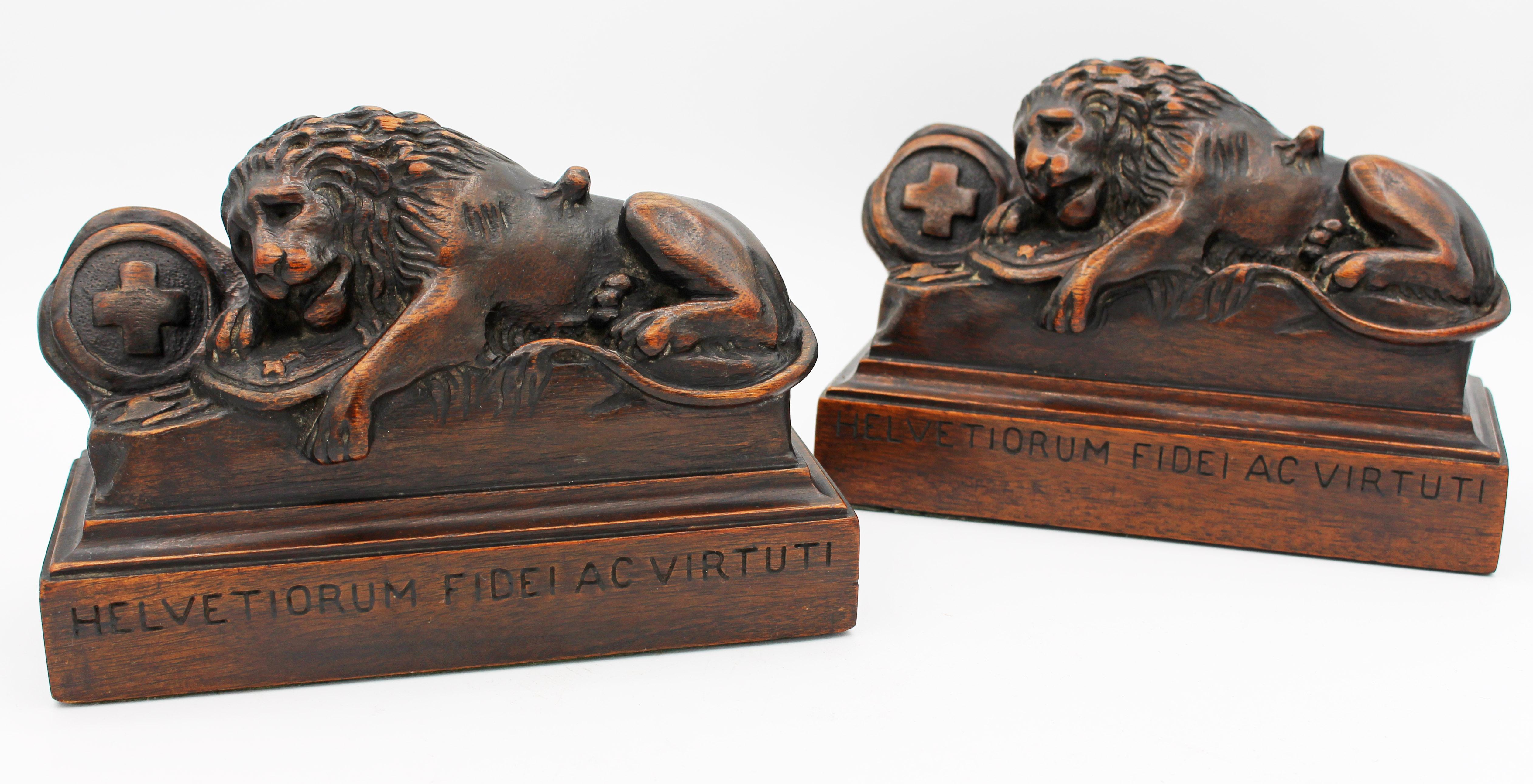 A pair of carved mahogany bookends, c.1920. The lion of Lucerne with the inscription Helvetiorum Fidei Ac Virtuti (To the Loyalty and Bravery of the Swiss). The monument was designed by Bertel Thorvaldsen & sculpted by Luka Ahorn to memorialize the