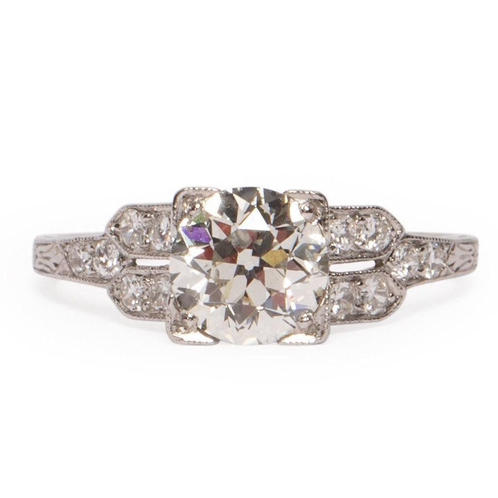 This Art Deco beauty is an excellent example of the 1920's era. The Beautiful diamond detail split shanks are just one attribute that makes this ring so unique. Atop the Diamond Shanks is a beautiful Old European Cut 1.34 Ct Diamond that will take