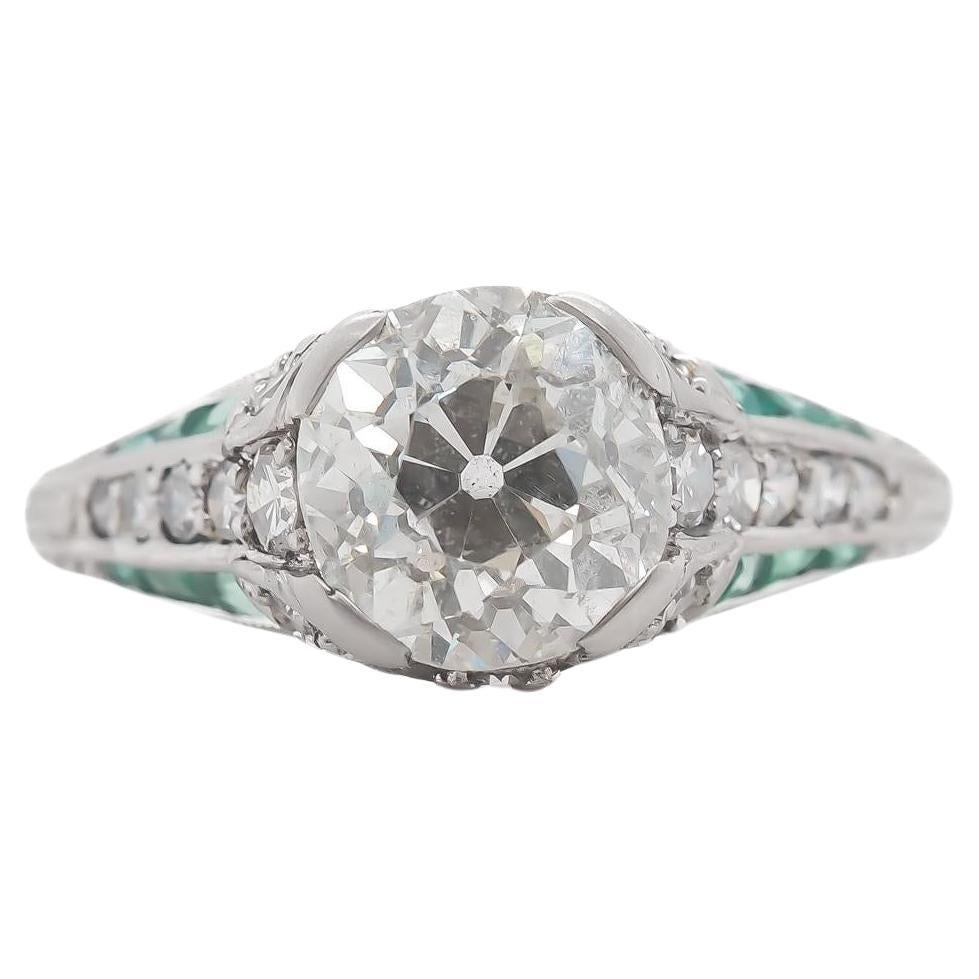 Circa 1920s Platinum 2.03ct Old European Cushion Diamond and Emerald Engagement