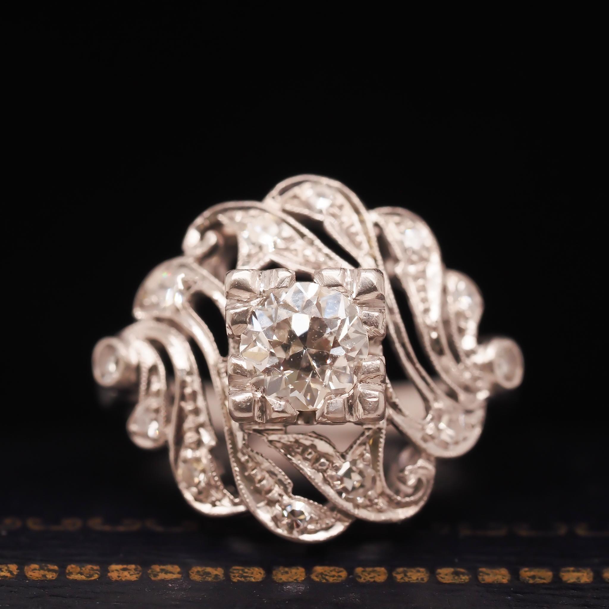 Year: 1920s
Item Details:
Ring Size: 6 (Sizable)
Metal Type: Platinum [Hallmarked, and Tested]
Weight: 7.6 grams
CenterDiamond Details: .50ct, old European brilliant, G color, VS Clarity
Side Diamond Details: .10ct total weight, antique single cut,