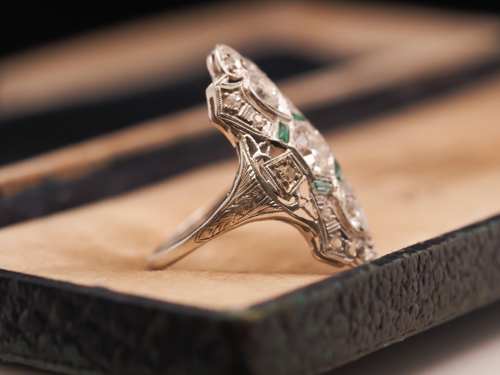 Art Deco Circa 1920s Platinum Shield Ring with Old European Cut Diamond and Emeralds For Sale