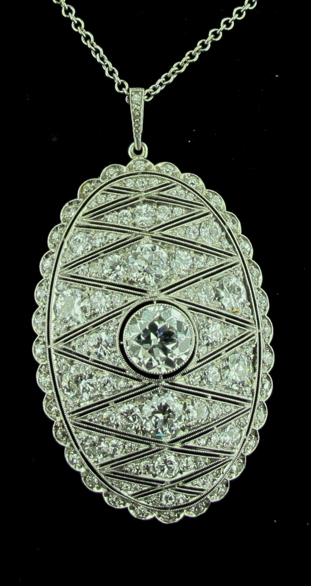 From the Art Deco period, circa 1925, is this diamond pendant set in Platinum.  The Center Diamond weighs 1.50 carats.  Color is H, Clarity is VS.  The Oval Pendant is covered with round cut diamonds with a total diamond weight of 3.75 carats.