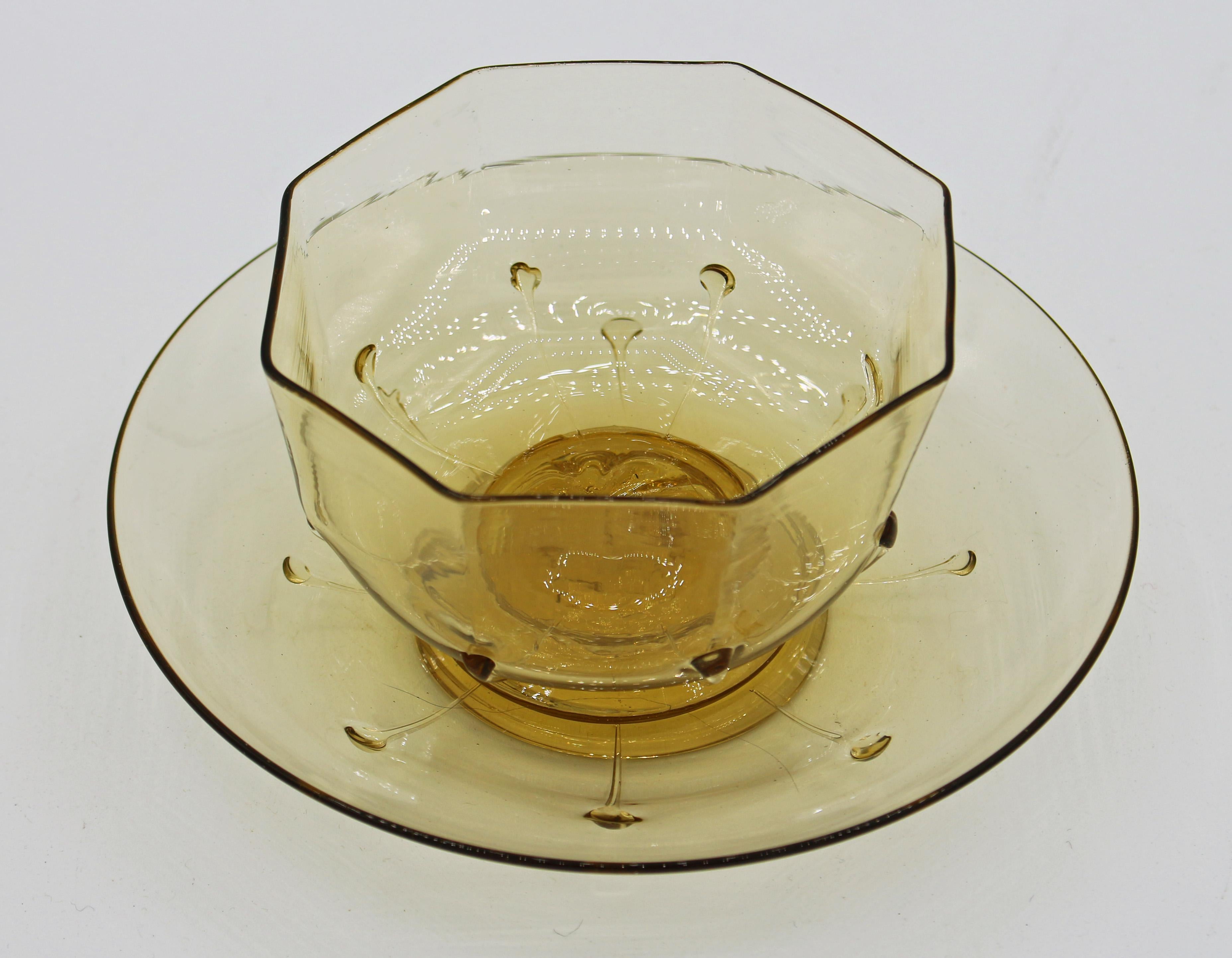 A rare dessert coupe and tray, c. 1925, Murano Salviati Venetian hard blow glass, citrine to light topaz. The octagonal bowl with droplets has a pulled sand dollar or leaf motif above the foot with pontil. Tray has 8 droplets from applied base rim.