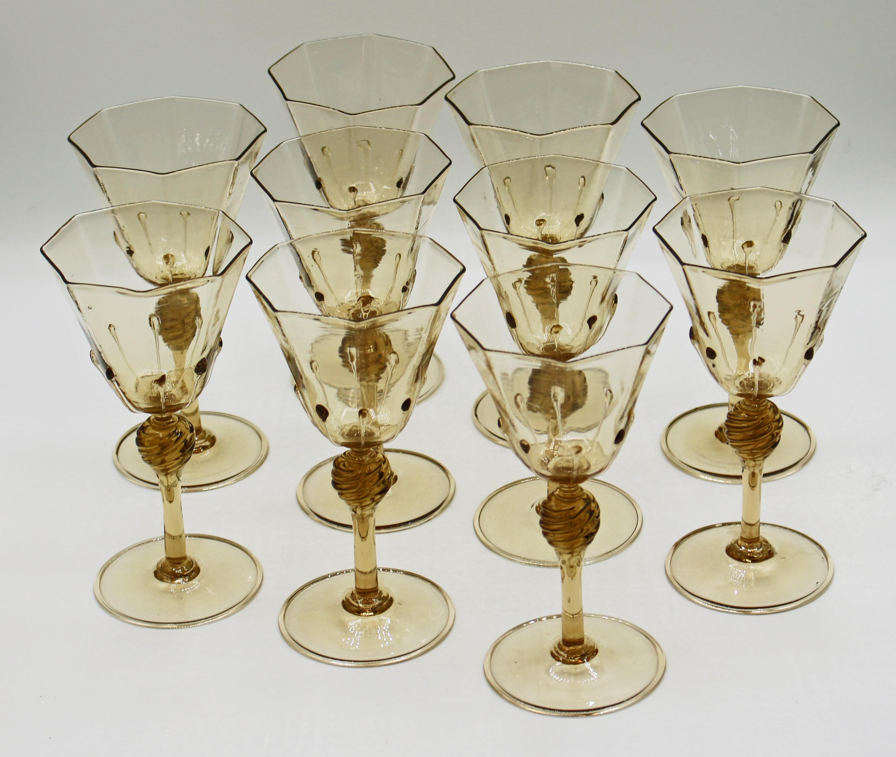 A set of ten Venetian goblets, blown glass for water or red wine, citrine to light topaz color, with twisted stem knop, 8-panelled bodies with droplets on each ridge. Each a tour de force of the glass blower's art. c.1925. Attributed to Salviati,