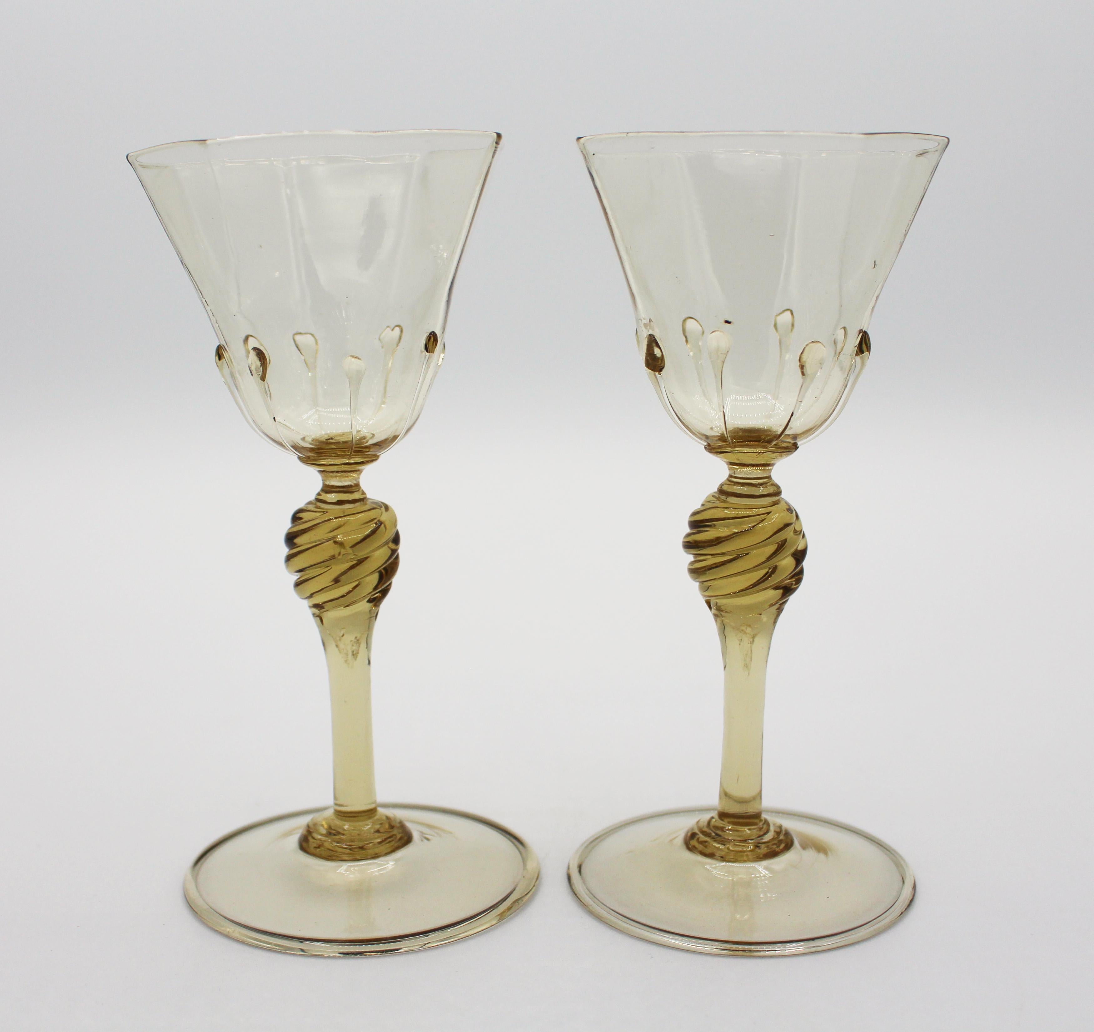 A pair of toasting glasses, c.1925, octagonal citrine to light topaz color glass with swirl knop stems and droplets on each ridge. Salviati, Murano Venetian glass. Approx 6 1/8
