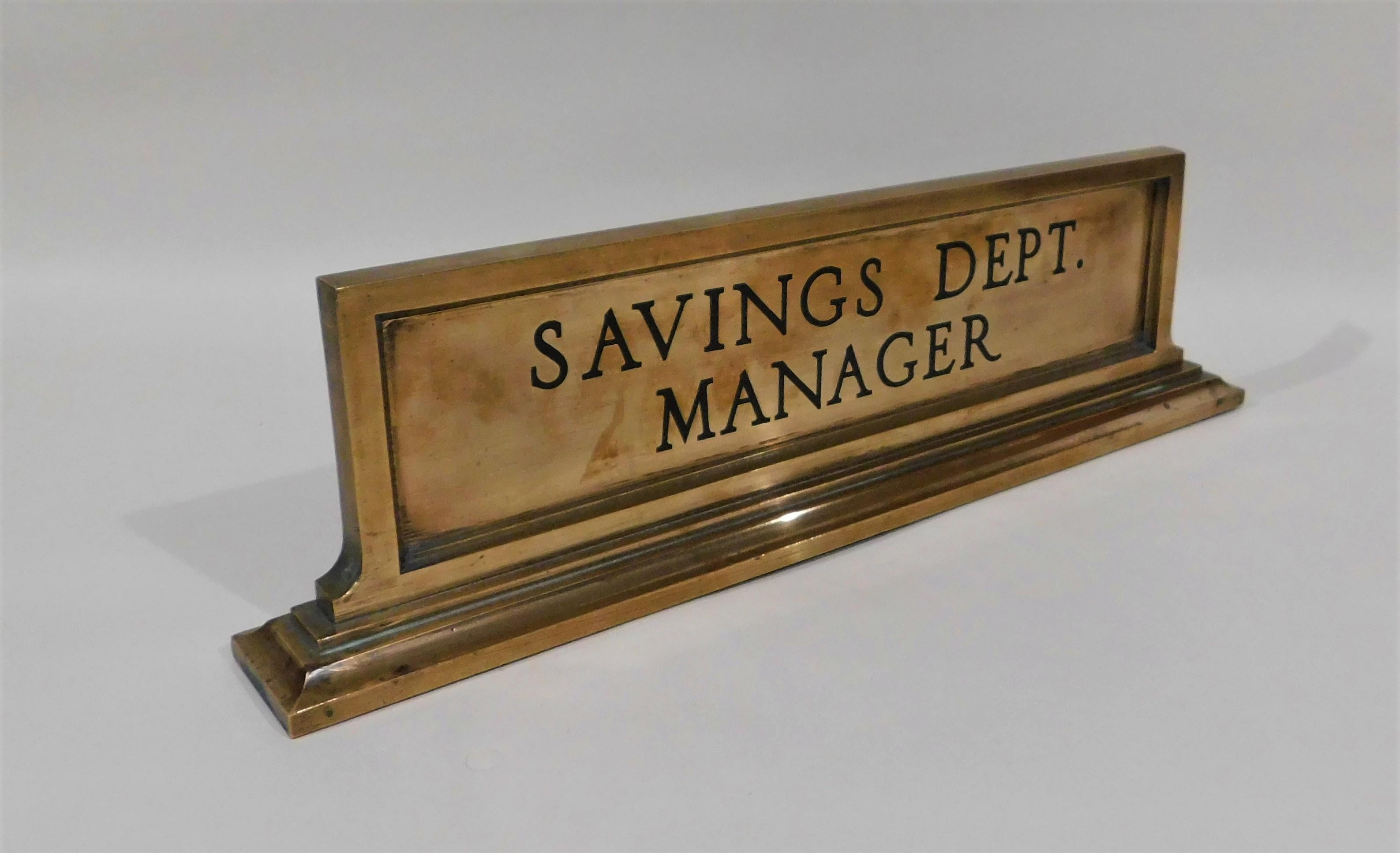 Heavy bronze metal bank savings department manager desk name plate in very good condition, circa 1925. Has felt material on the bottom.