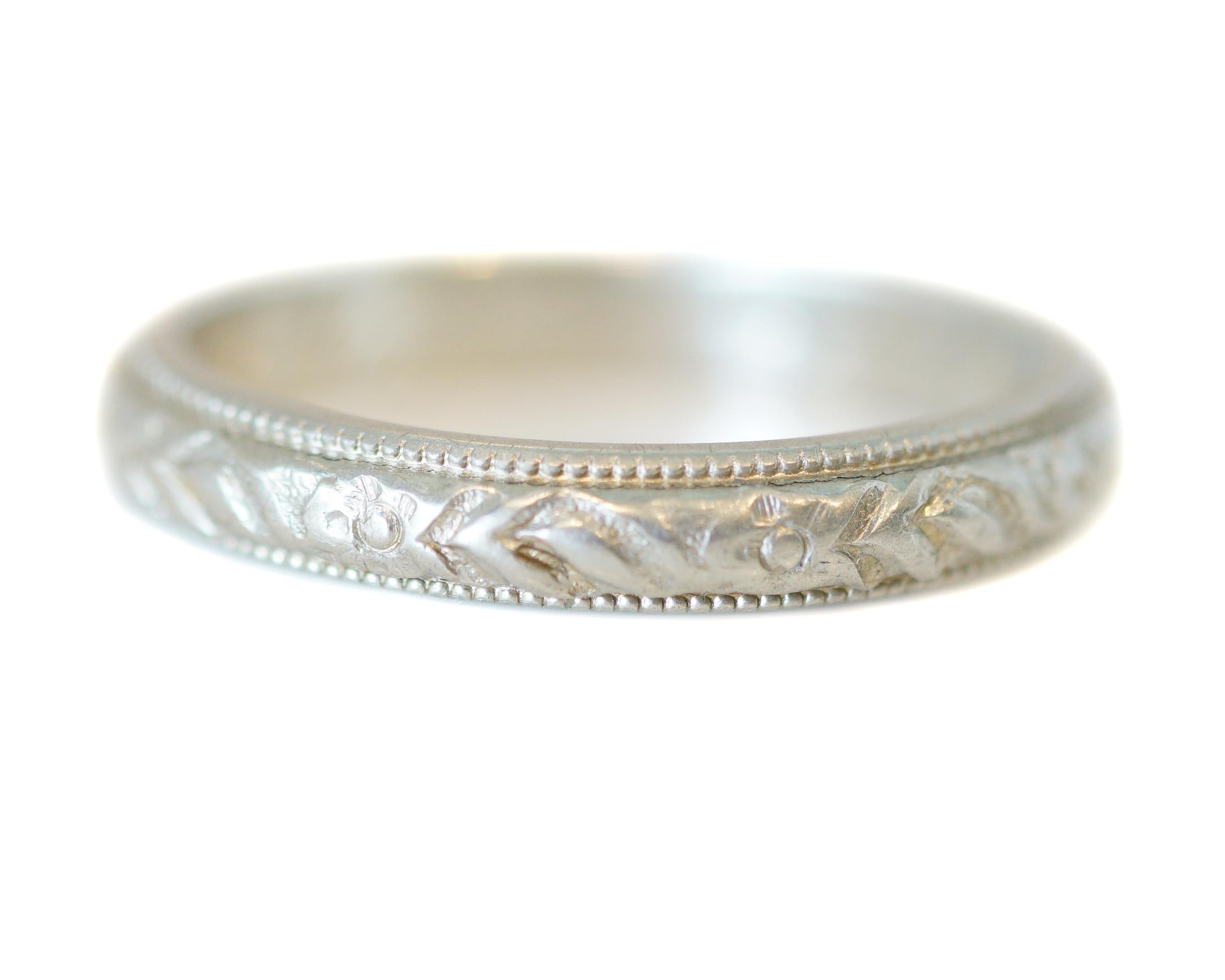 Description: 
This piece is a 1926 Art Deco era 18k White Gold wedding band! A charming wedding band like this one will pair wonderfully with any engagement ring! Original engraving brings mystery and romance to this amazing genuine antique