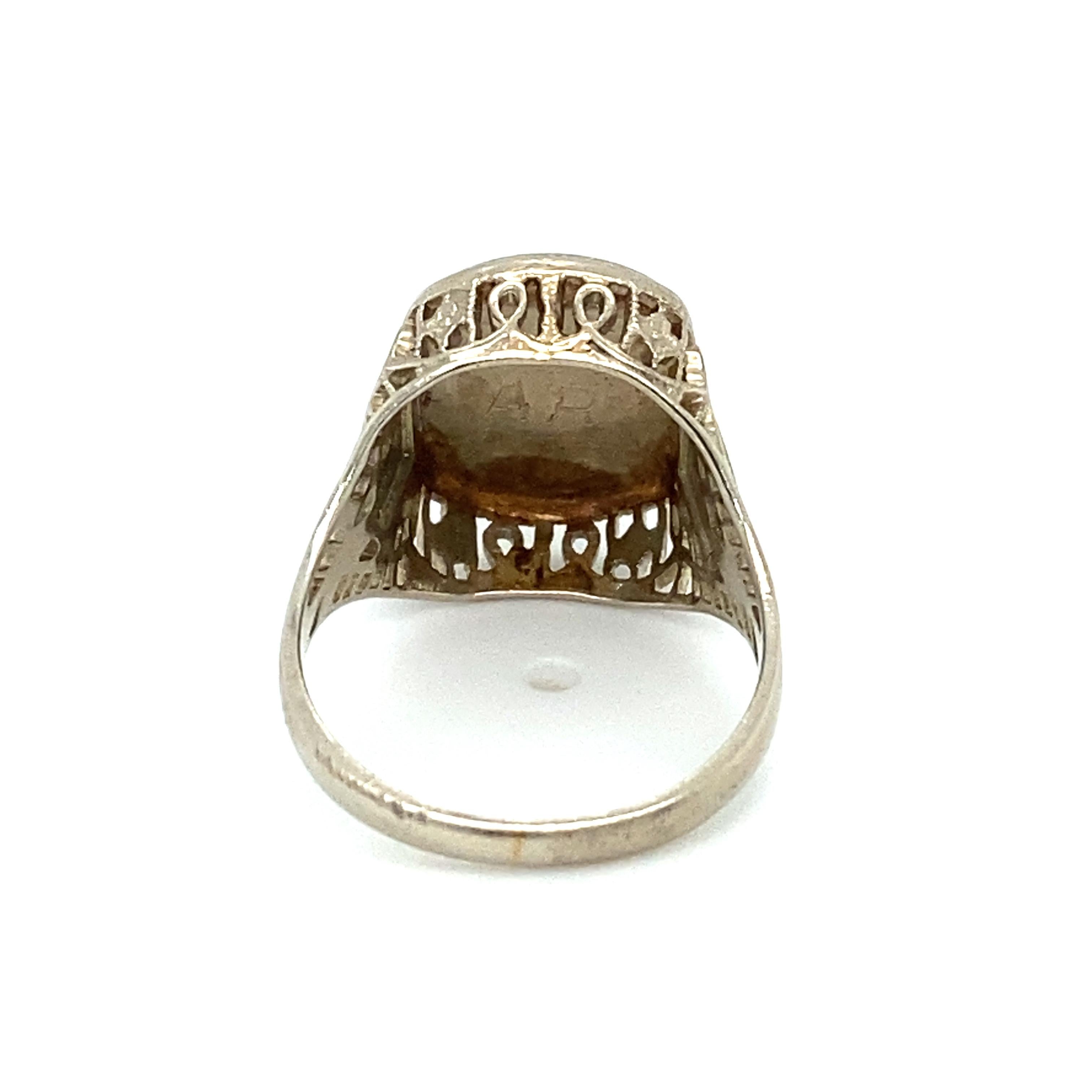 Item Details: This class ring is dated 1928 and features the initial E and an inscribed initials AR on the underside. It is crafted in 14 karat white and yellow gold. The gallery work is absolutely beautiful and intricate, reflecting the true art