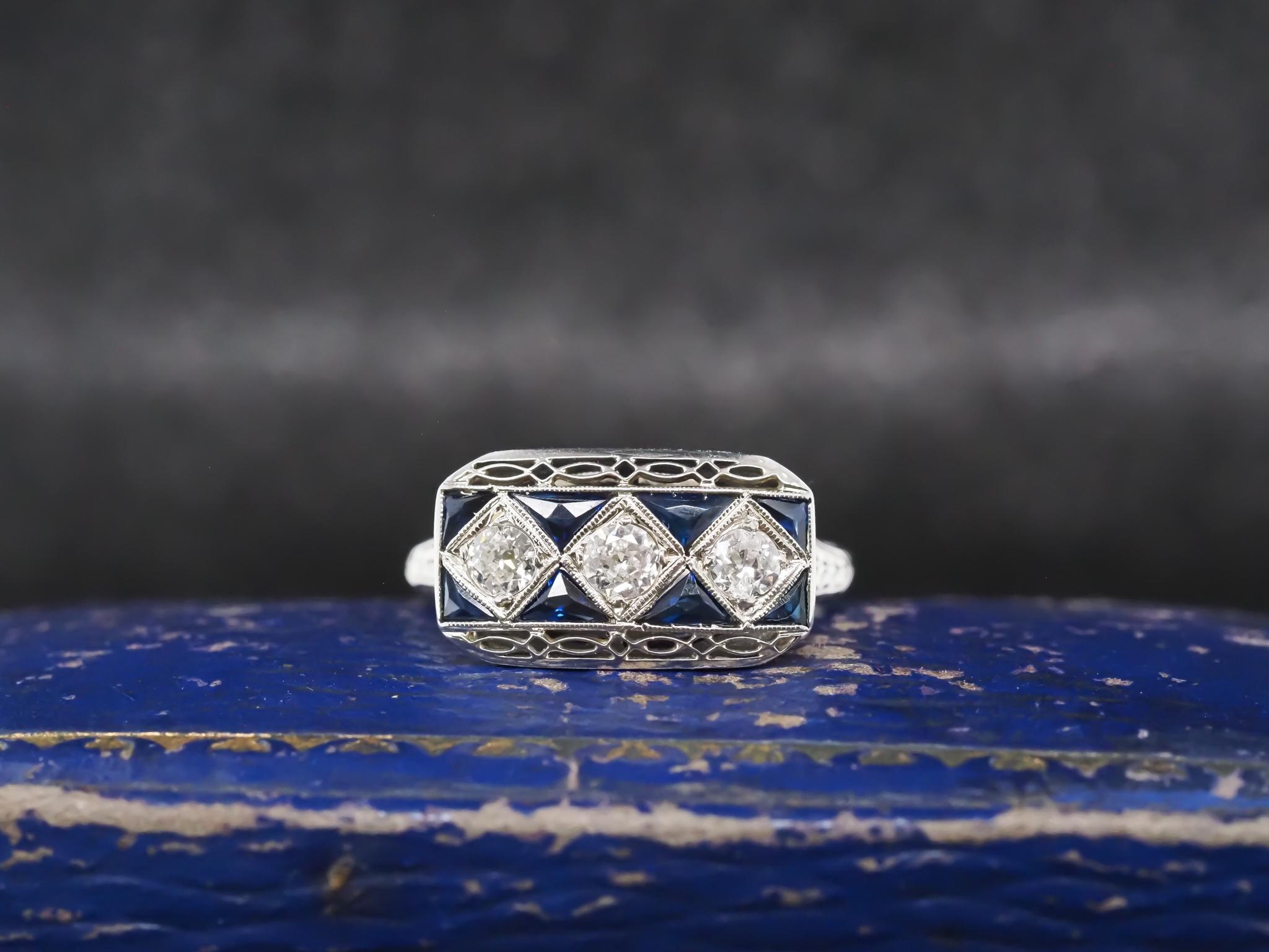 Year: 1930s

Item Details:
Ring Size: 6 (Sizable)
Metal Type: 20K White Gold [Hallmarked, and Tested]
Weight: 3.8 grams

Diamond Details: .45ct total weight, G color, VS clarity, Natural, Old European Brilliant

Side Stone Details: Natural French