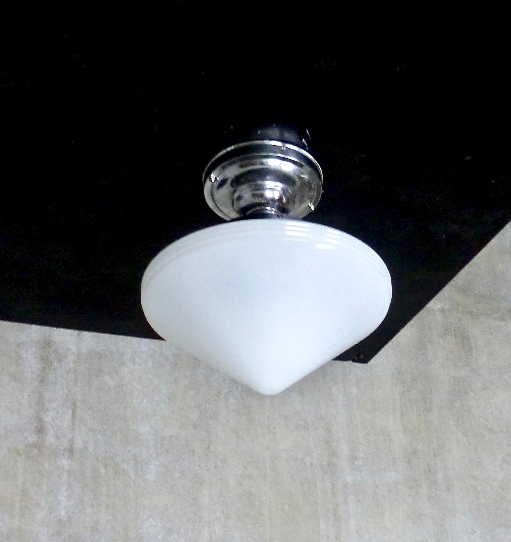 You can never go wrong with the graceful lines of a triangular-shaped milk glass pendant. Subtle ribbed details in the glass; bright chrome fitter. Re-wired and approved to current electrical standards; ceiling mounting plate included. Forever