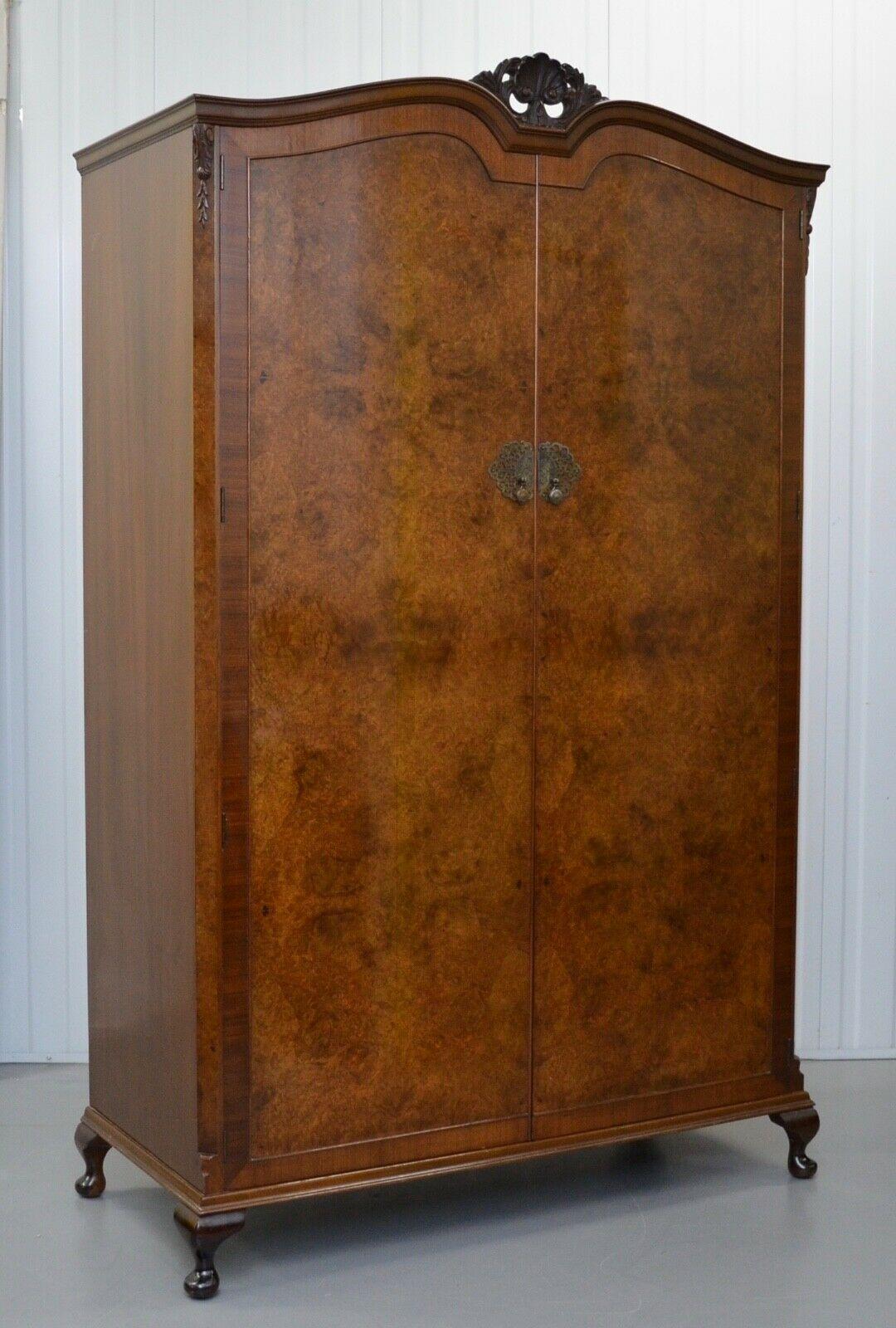 We are delighted to offer for sale this wonderful circa 1930 Art Deco heavily figured walnut double wardrobe. it is very functional offering two full-length hanging areas, and one shelf standing on short cabriole legs, and is in excellent