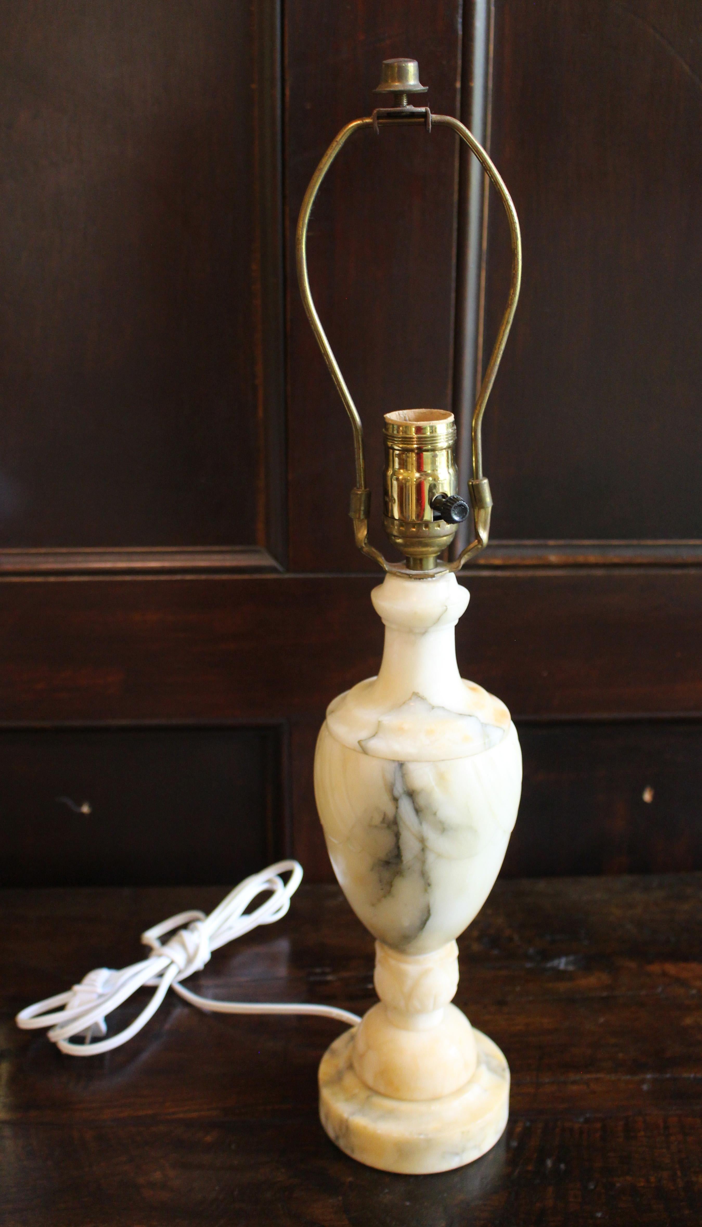 Circa 1930 Italian carved marble table lamp. The urn & support feature leaf carving. Grey & amber streaked white stone now somewhat yellowed with age (a few dark spots as well). 1/2