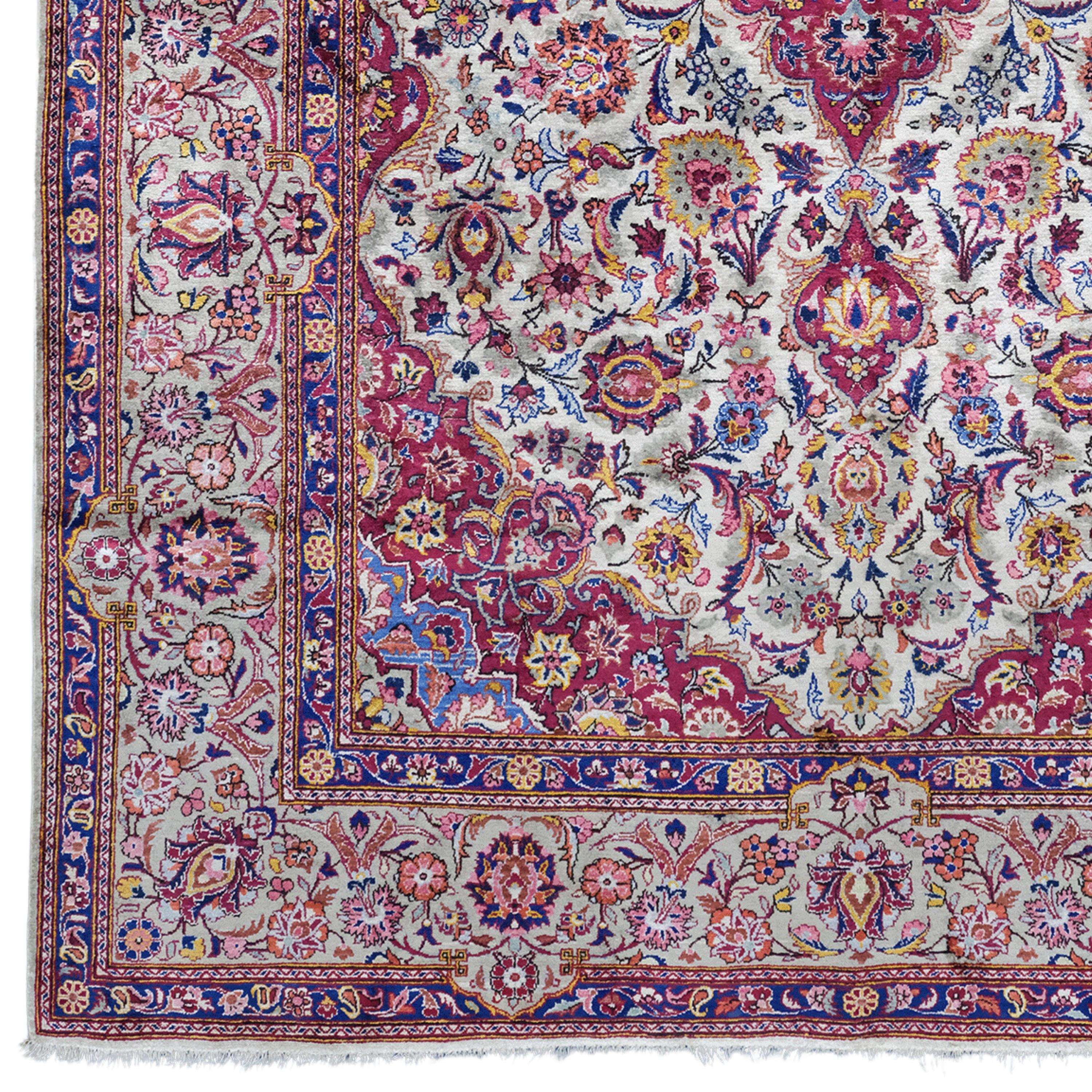 This early 20th-century antique Keshan rug is notable for its rich colors, intricate pattern and hand-woven craftsmanship.

Pattern and Colors: This rug is decorated with an intricate pattern in deep shades of red and blue. Traditional Keshan motifs