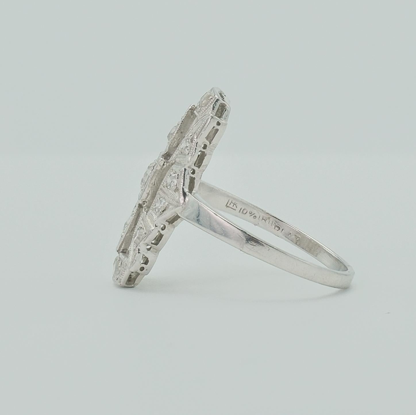 This exceptional Art Deco diamond ring features 15 old European cut VS1-VS2 diamonds with a total weight of 0.35 carats. Uniquely crafted in a rectangular geometric shape and set in platinum, the ring's precise metalwork provides a gentle shimmer