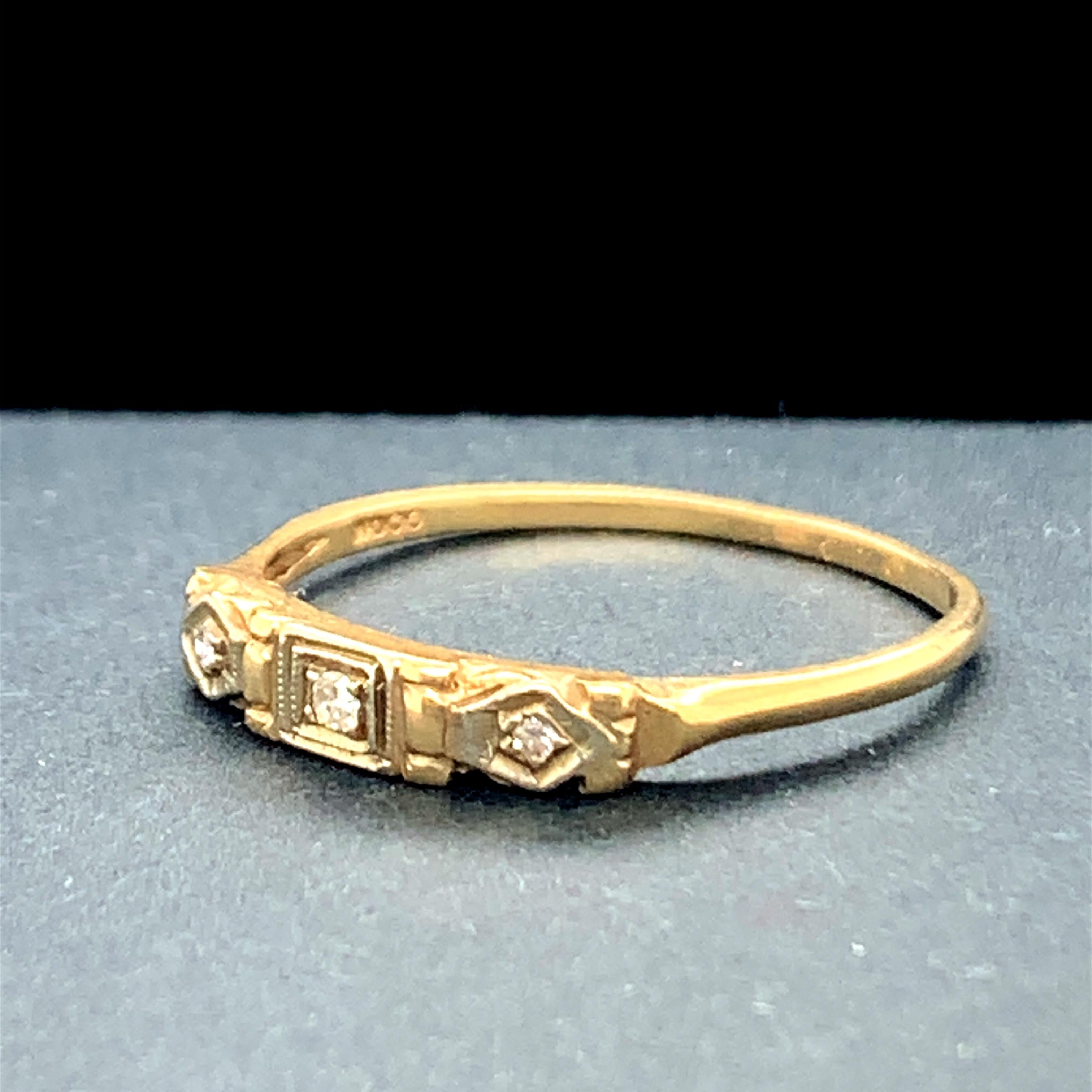 Year: 1930s

Item Details: 
Ring Size: 7
Metal Type: 14k Yellow Gold  [Hallmarked, and Tested]
Weight:  1.2 grams

Diamond Details:
Weight: ..06ct, total weight
Cut: Old European brilliant
Color: G
Clarity: VS

Finger to Top of Stone Measurement: