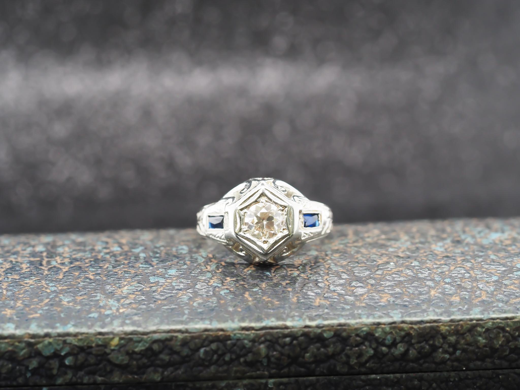 Year: 1920s
Item Details:
Ring Size: 9 (Sizable)
Metal Type: 18k White Gold [Hallmarked, and Tested]
Weight: 6.0 grams
Diamond Details: .80ct, Fancy Light Brown, VS Clarity, Old European Brilliant
Side Stone Details: Sapphire, synthetic, rectangular