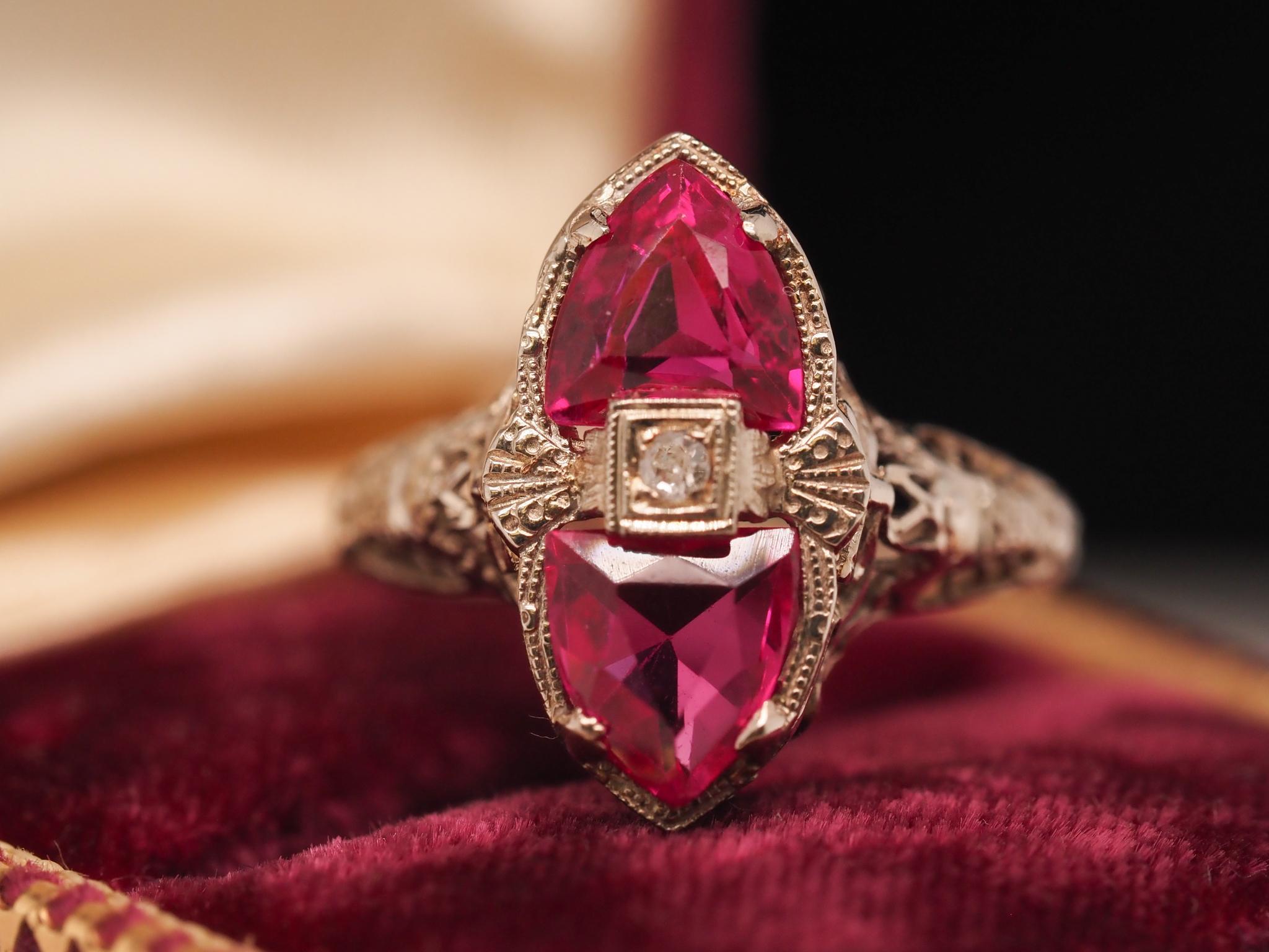 Year: 1930s
Item Details:
Ring Size: 8 (Sizable)
Metal Type: 18k white gold [Hallmarked, and Tested]
Weight: 2.7 grams
Ruby Details: Synthetic, Intense Pink-Red, 2 carat total weight
Band Width: 2mm
Condition: Excellent
Era: Art Deco