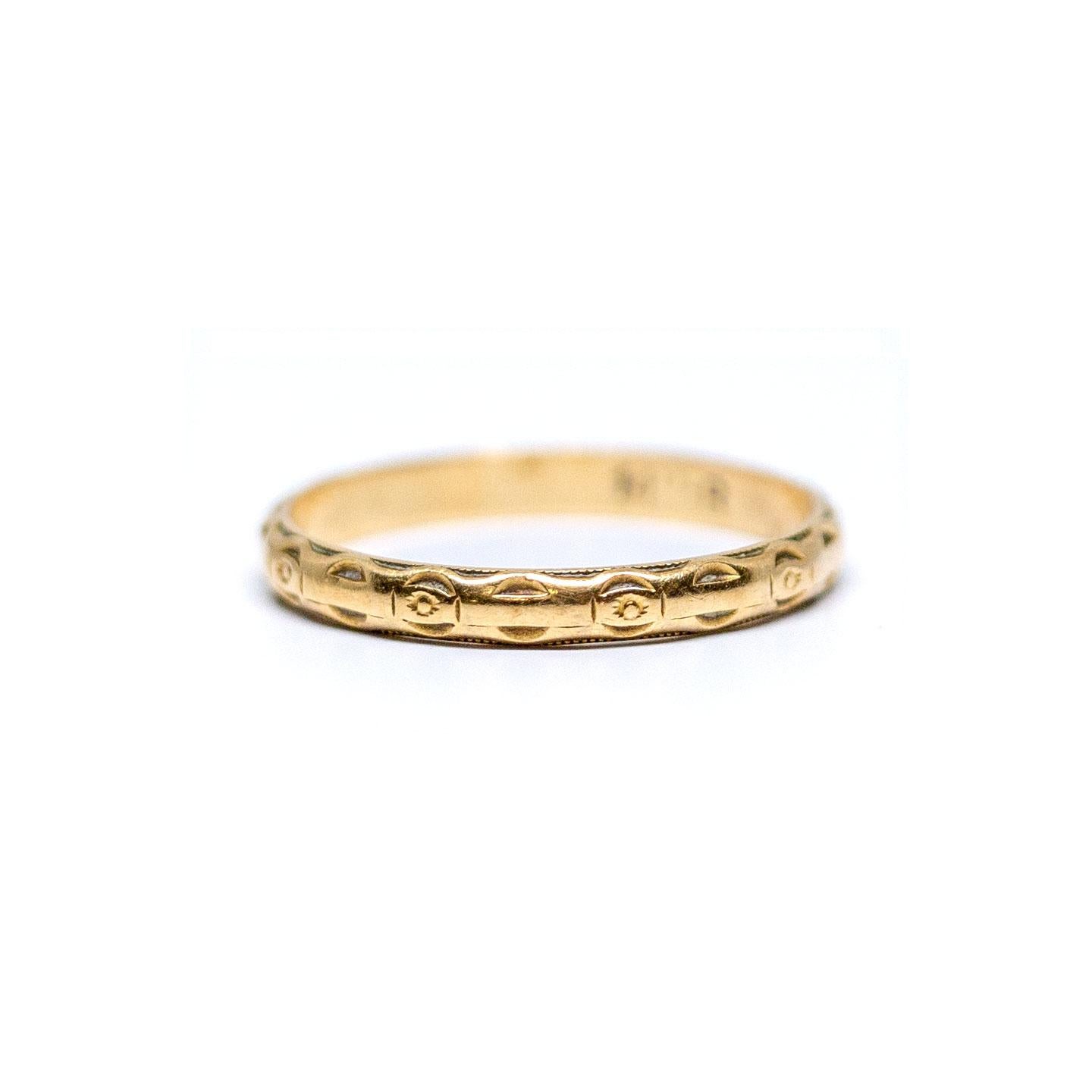 Description: 
This piece is a genuine 1930's 14k yellow gold wedding band! This beautiful dainty band is an excellent example of early 20th century style! Likely from the 1930's this Art Deco beauty features a great deep relief carved design all of