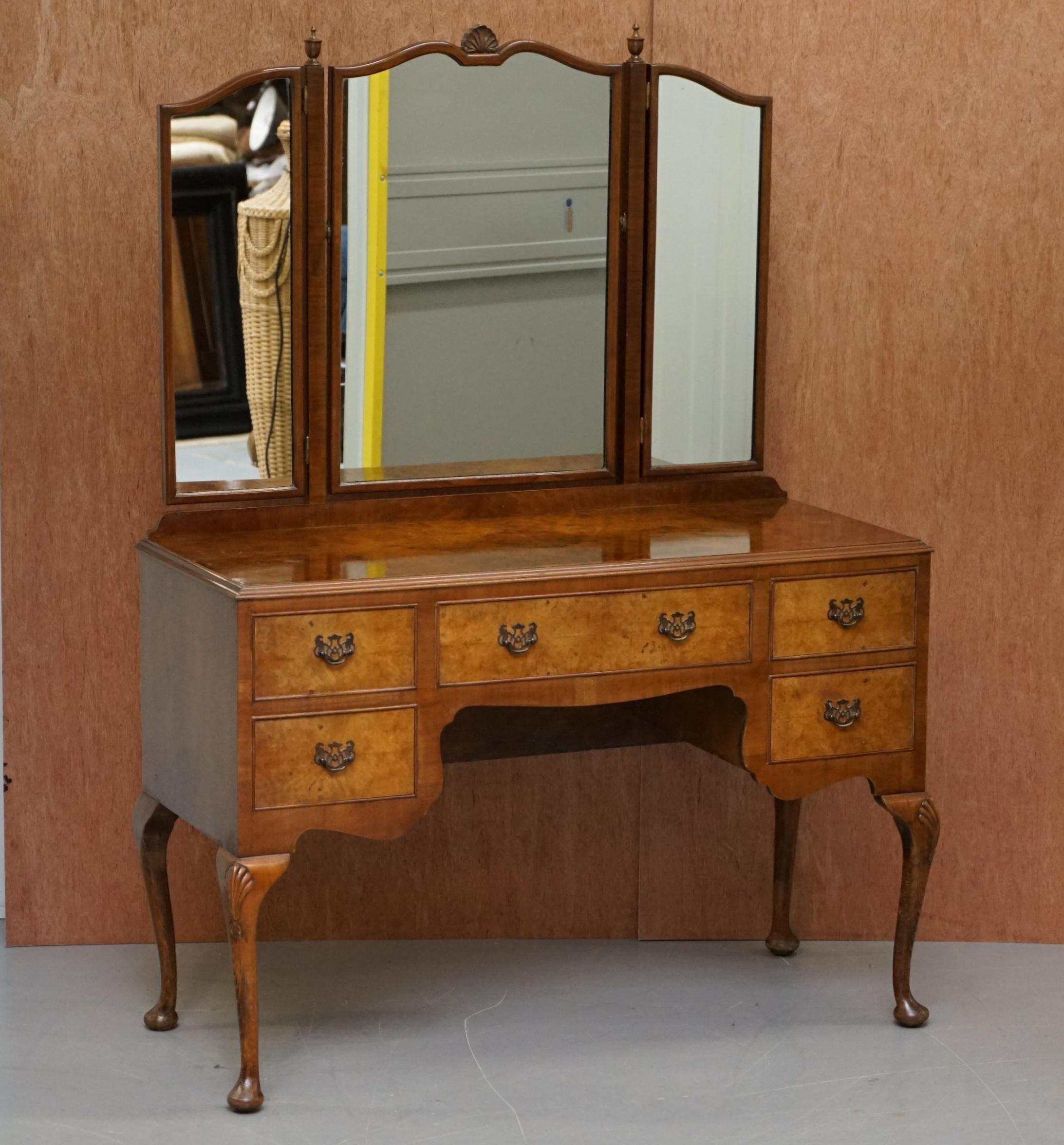 We are delighted to offer for sale this stunning circa 1930s Figured Walnut dressing table and stool with Tri-folding mirrors

This dressing really is exquisite, the walnut simply glows in the right light, the tri-fold mirrors are easily