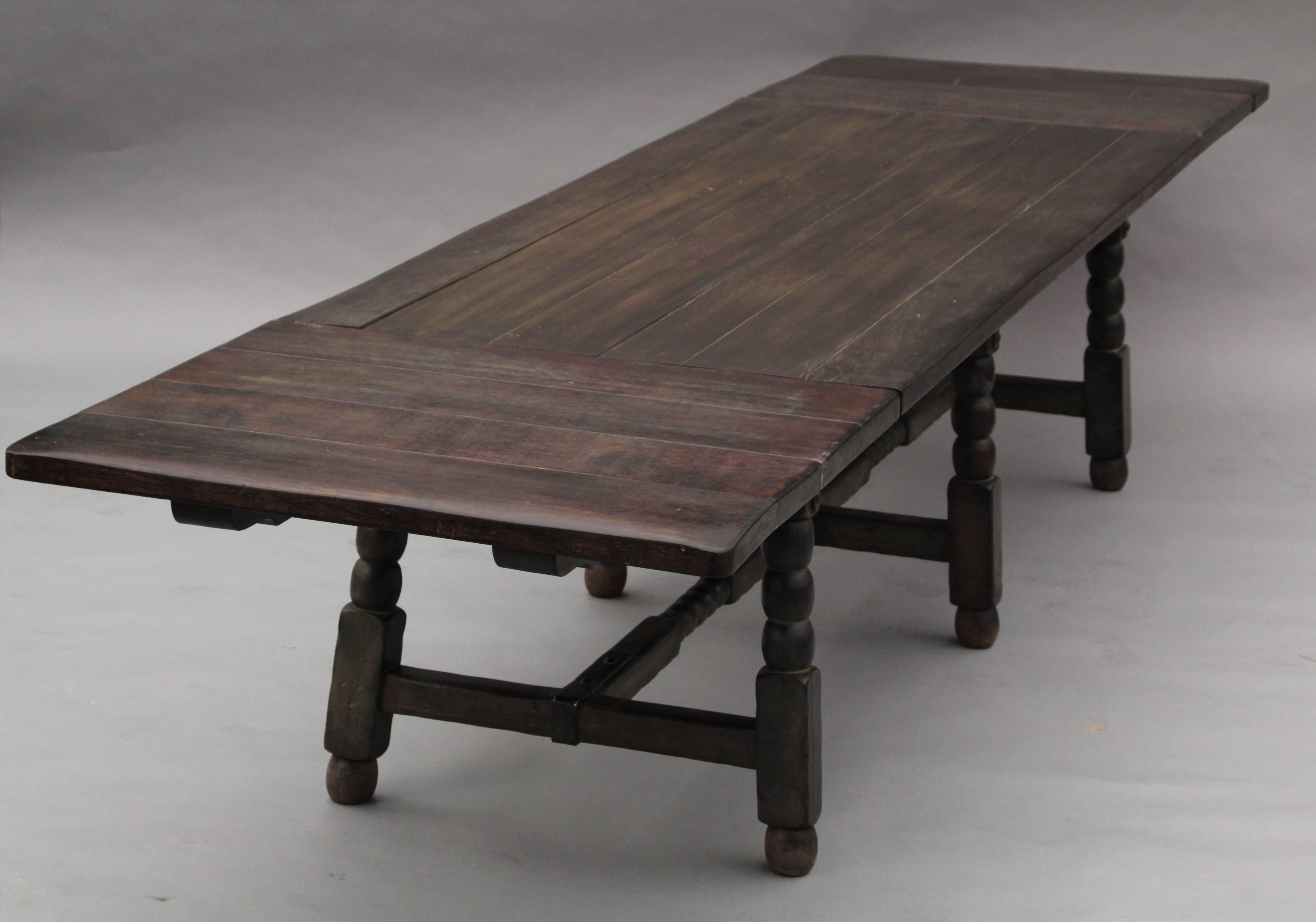 Very long Monterey table named the Bela Lugosi table as this model was initially designed for the actor in the 1930s by the Monterey Company. Few of these tables have been made. The table has six leafs and is branded Monterey.
The table has 4 leafs