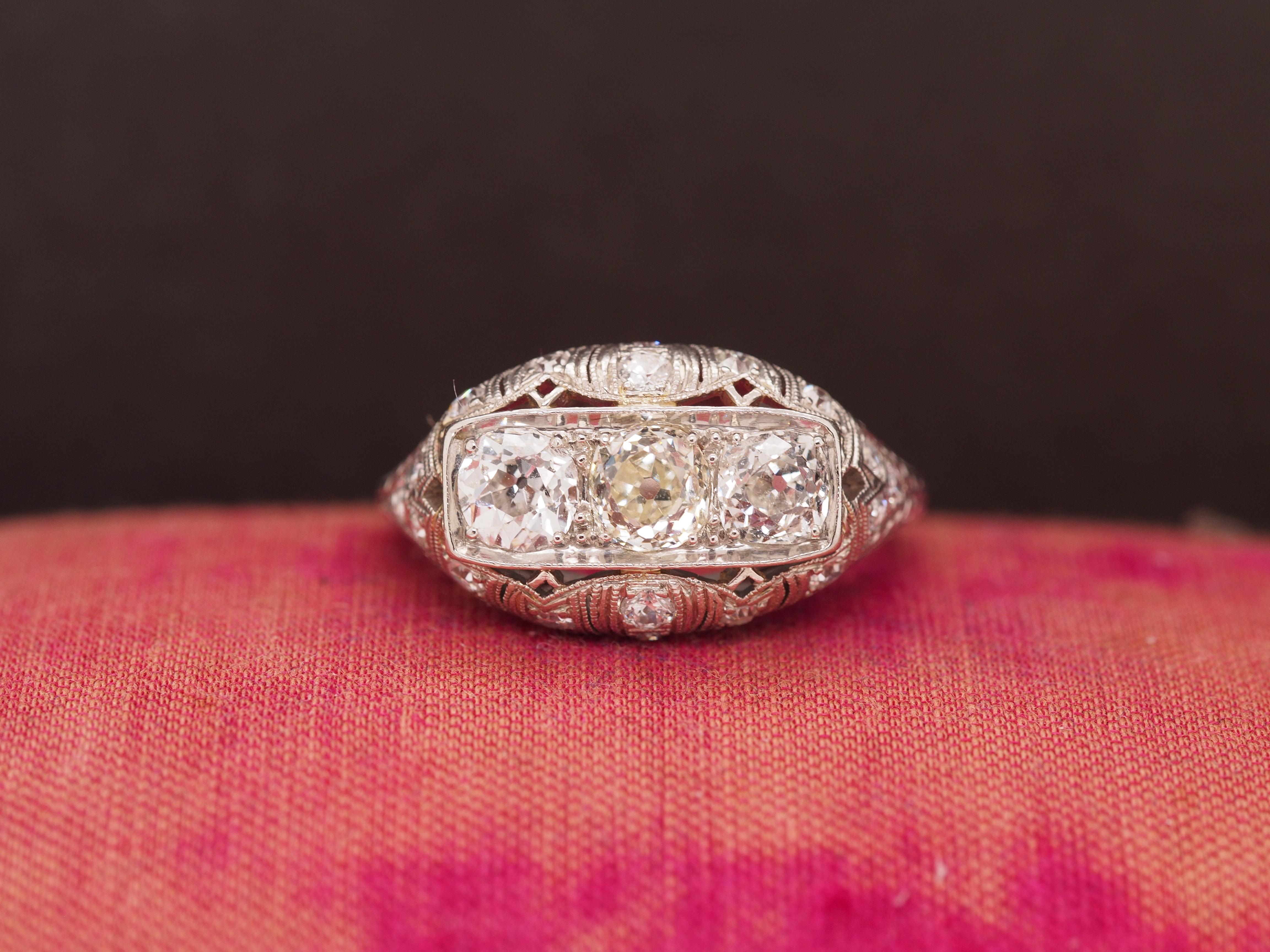 Year: 1930s
Item Details:
Ring Size: 6.25
Metal Type: Platinum [Hallmarked, and Tested]
Weight: 5.5 grams
Diamond Details: .40ct each x 3 Center Diamonds = 1.20ct, total. H/I color, VS clarity, Old mine brilliant
Side Stone Details: .20cttw, old