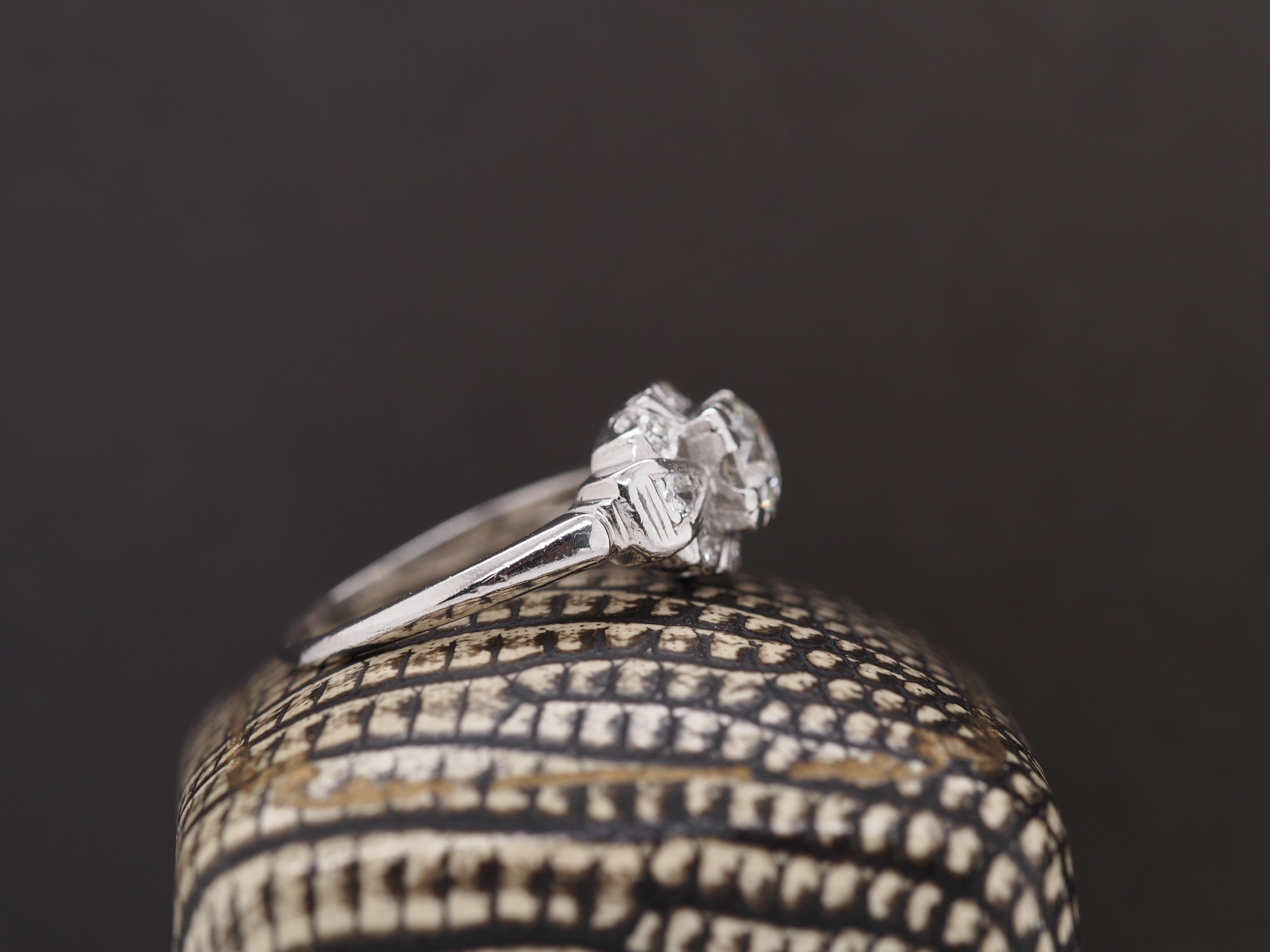 Year: 1930s

Item Details:
Ring Size: 5.8
Metal Type: Platinum [Hallmarked, and Tested]
Weight: 3.6 grams

Center Diamond Details:

.65ct Center Stone, Natural Diamonds, I Color, VS Clarity, Old European Brilliant Shape

Side Diamonds: .15ct total