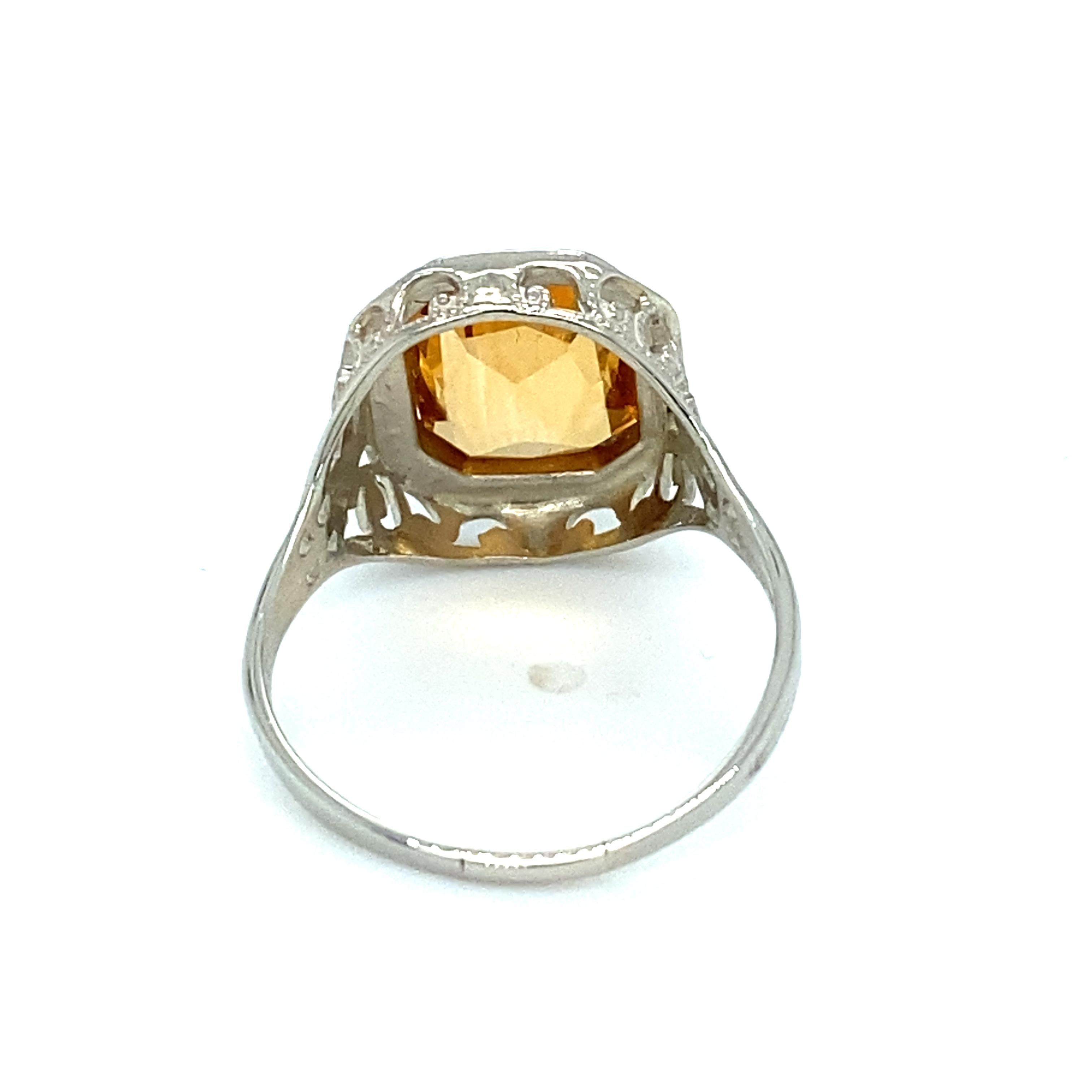 Artikel-Details: Dieser Art-Déco-Ring aus den 1930er Jahren hat ein filigranes Design mit einem leuchtenden Citrinstein in der Mitte. 

Circa: 1930er Jahre
Metall-Typ:  14 Karat Weißgold
Gewicht: 2.0 Gramm 
Größe: US 6.5, größenverstellbar
