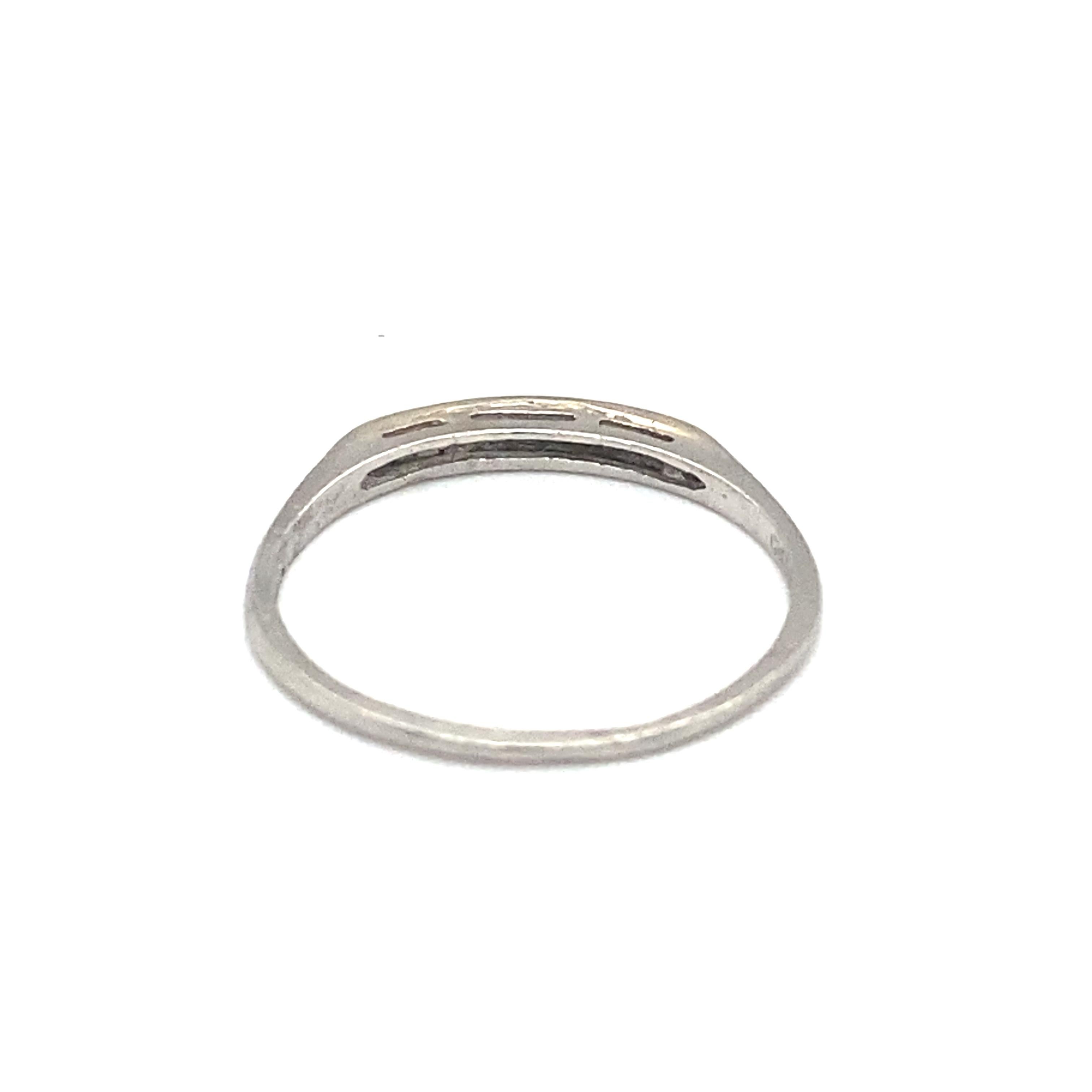 Item Details: This antique wedding band has round single cut and baguette diamonds and is inscribed with a date. It is platinum crafted and all diamonds are bezel. 

Circa: 1930s
Metal Type: Platinum
Weight: 1.9 grams
Size: US 8, resizable