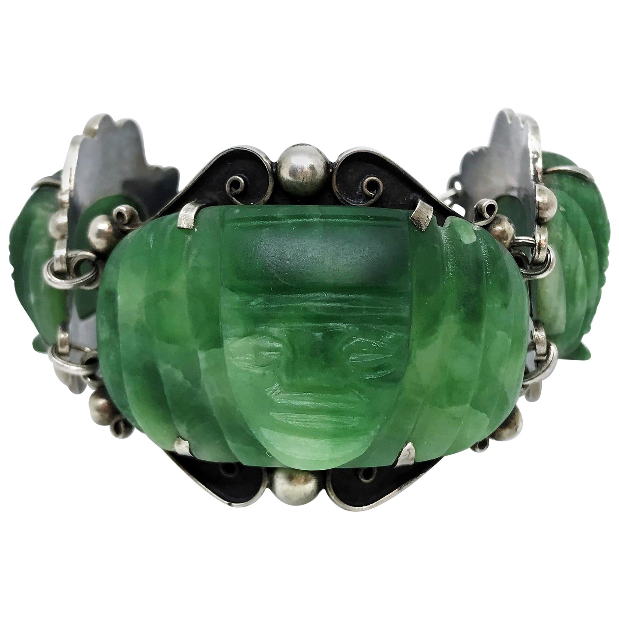 Circa 1930s Sterling Silver and Carved Green Onyx Mask Bracelet For Sale