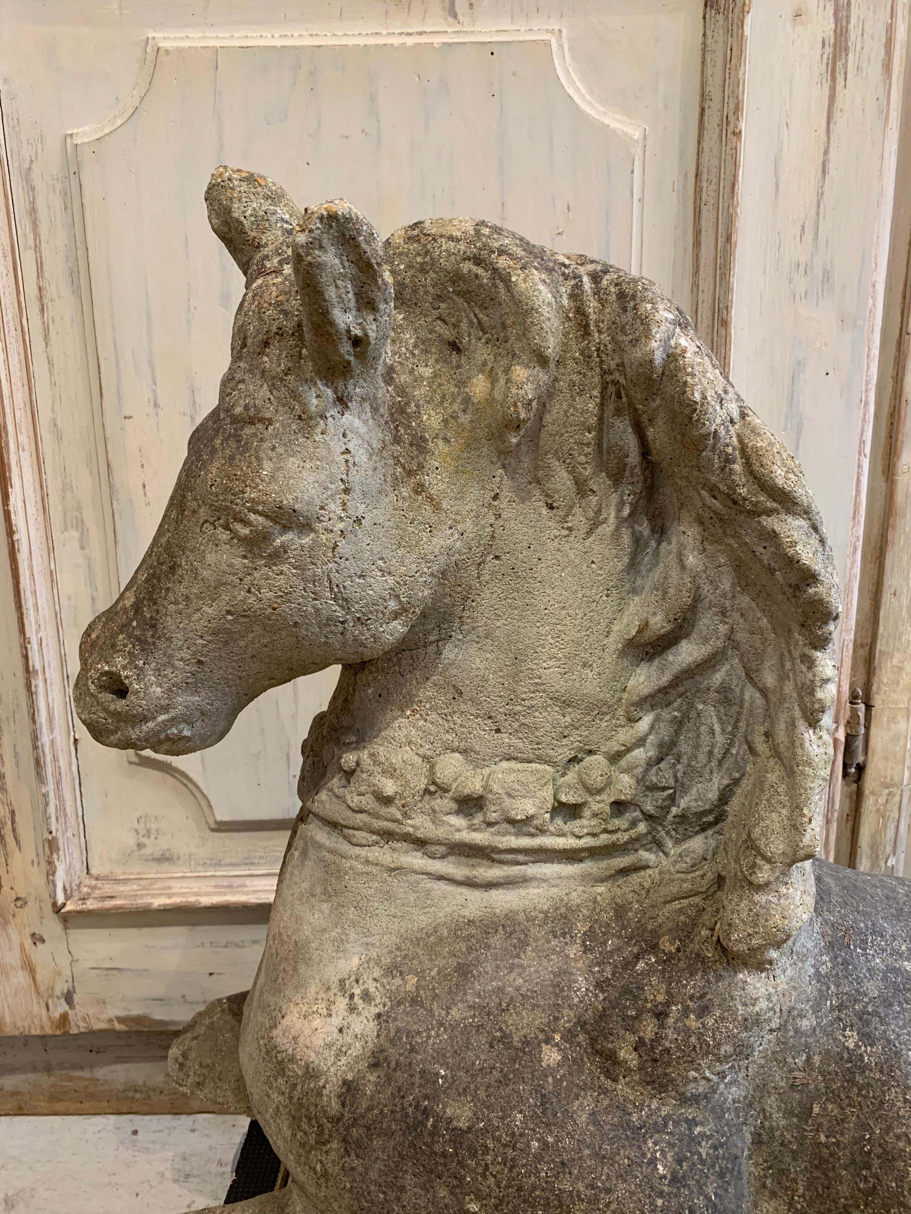 Reclaimed English composition figure of a recumbent horse, circa 1930s
Almost unicorn in its features the horse has a trailing mane and bejewelled decorative detailed collar.
Naturally weathered with age there is an old repair to the face and neck