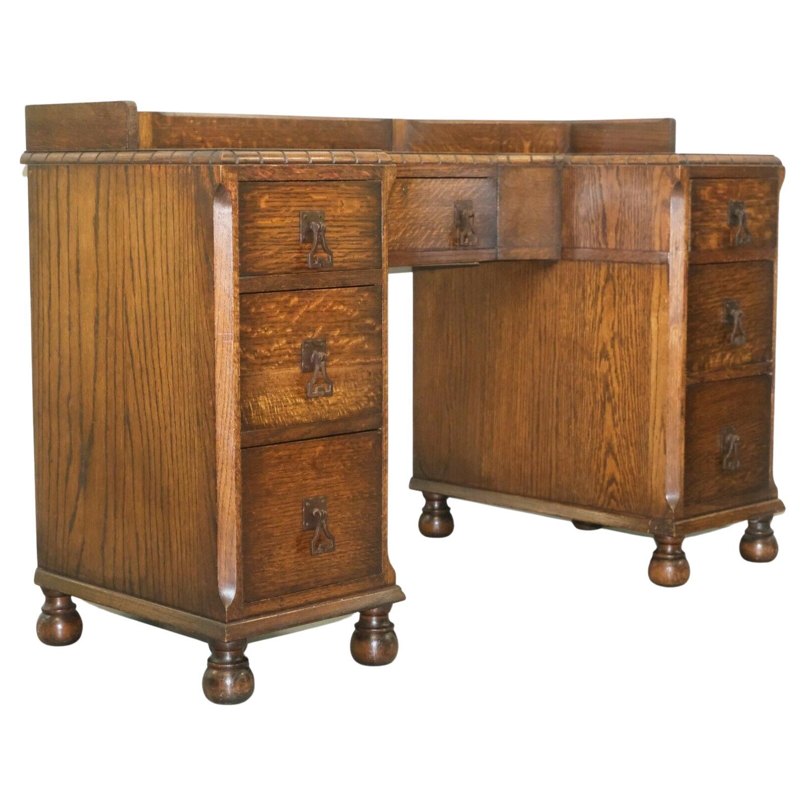Circa 1930's Waring & Gillow Ltd Lancaster Oak Desk on Bun Legs & Seven Drawers For Sale