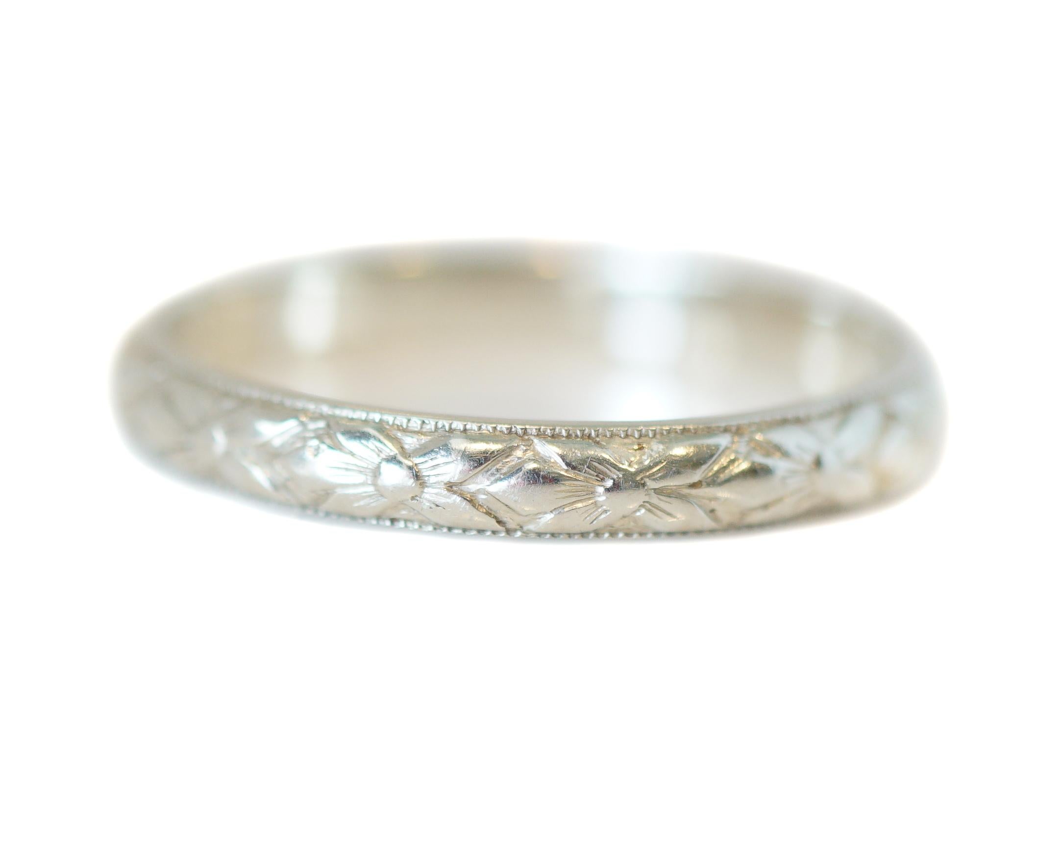Here we have a classic, elegant, and simple style wedding band. The floral design runs around the entire band and is simple and classic, with a fine milgrain edge making for a perfect vintage band example. It is a great piece to accompany an