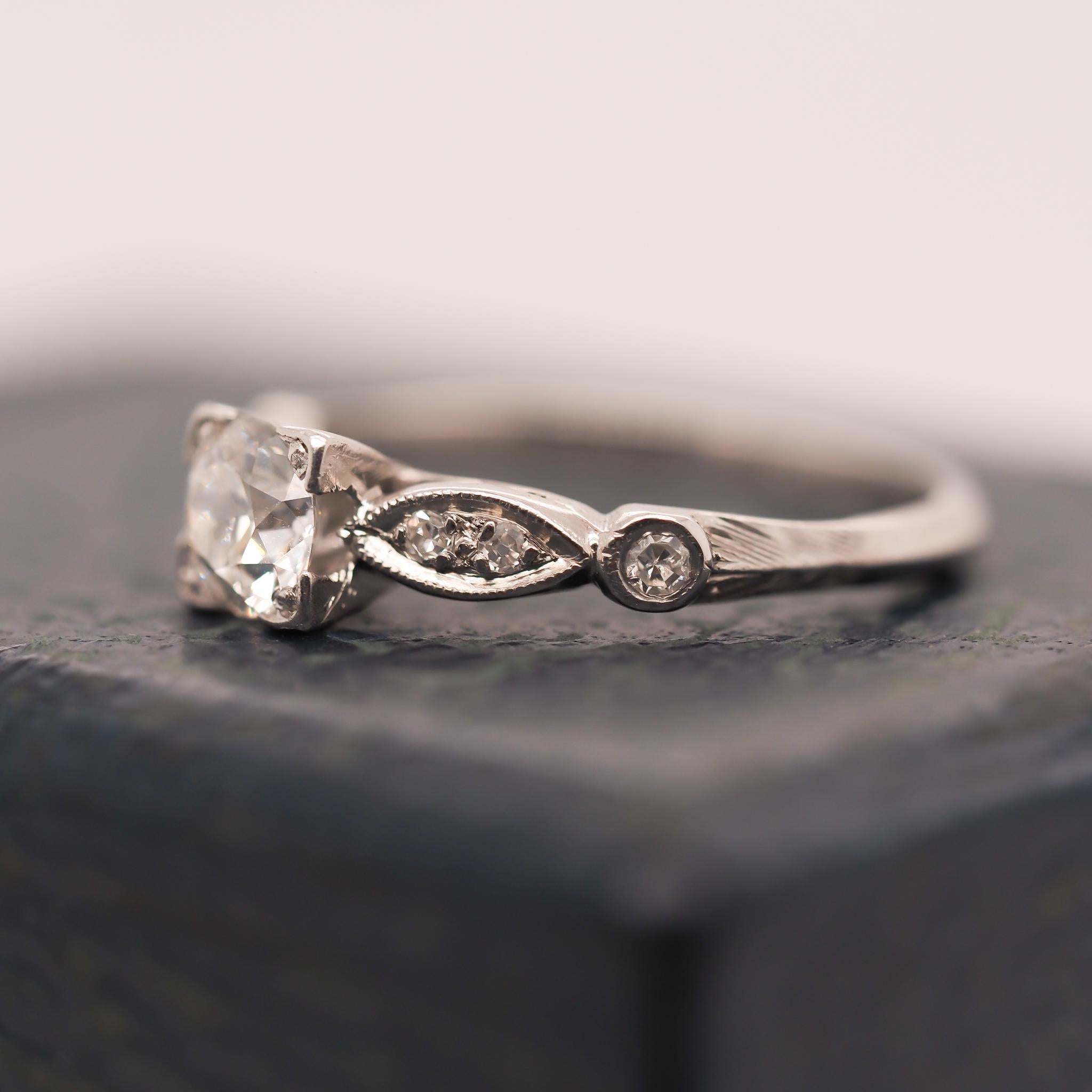 Year: 1938 (Engraved on the inside)

Item Details:
Ring Size: 5 (Sizable) Both rings are the same size
Metal Type: Platinum [Hallmarked, and Tested]
Weight: 4.3 grams

Center Diamond Details: .45ct, Old European Brilliant, E Color, VS Clarity.

Side