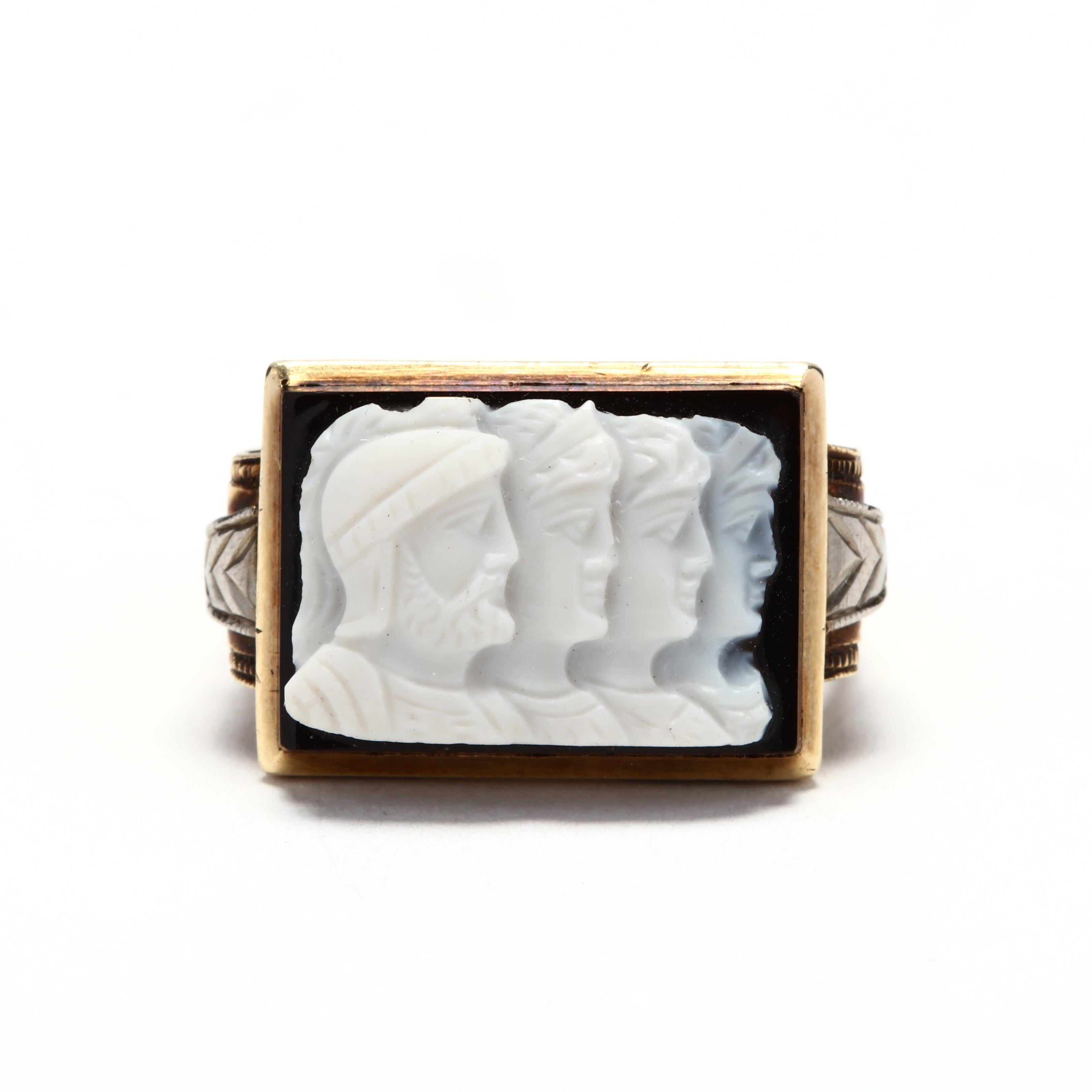 1940's 14 karat yellow and white gold sardonyx Roman soldier cameo ring. A rectangular, carved sardonyx cameo stone depicting the profiles of four Roman soldiers set in an engraved, rolled shoulder mounting.

Stones:
- sardonyx, 1 stone
-
