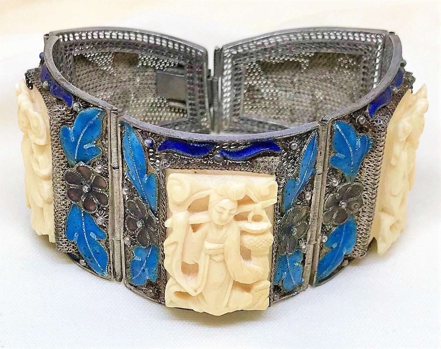 Circa 1940s Chinese sterling silver bracelet made up of five ornate mesh sections.  It is embellished with sterling floral, leaf and moth motifs enameled in purple, turquoise and dark blue enameling. The bracelet is bezel set with three, off-white,