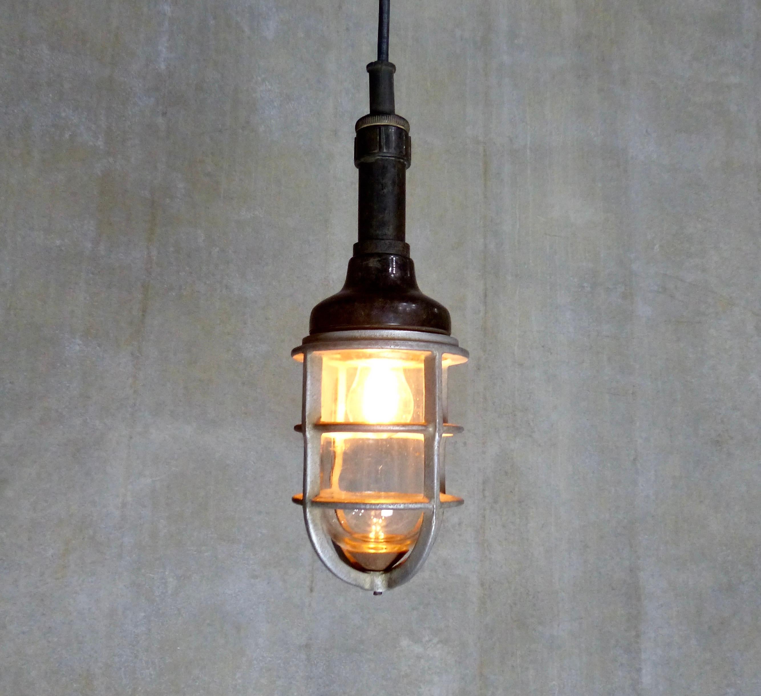 A circa 1940 General Electric industrial “trouble light’ converted into a pendant. Cast metal cage and glass shade with a Bakelite topper. Re-wired and inspected and approved to current electrical standards; ceiling mounting plate included.