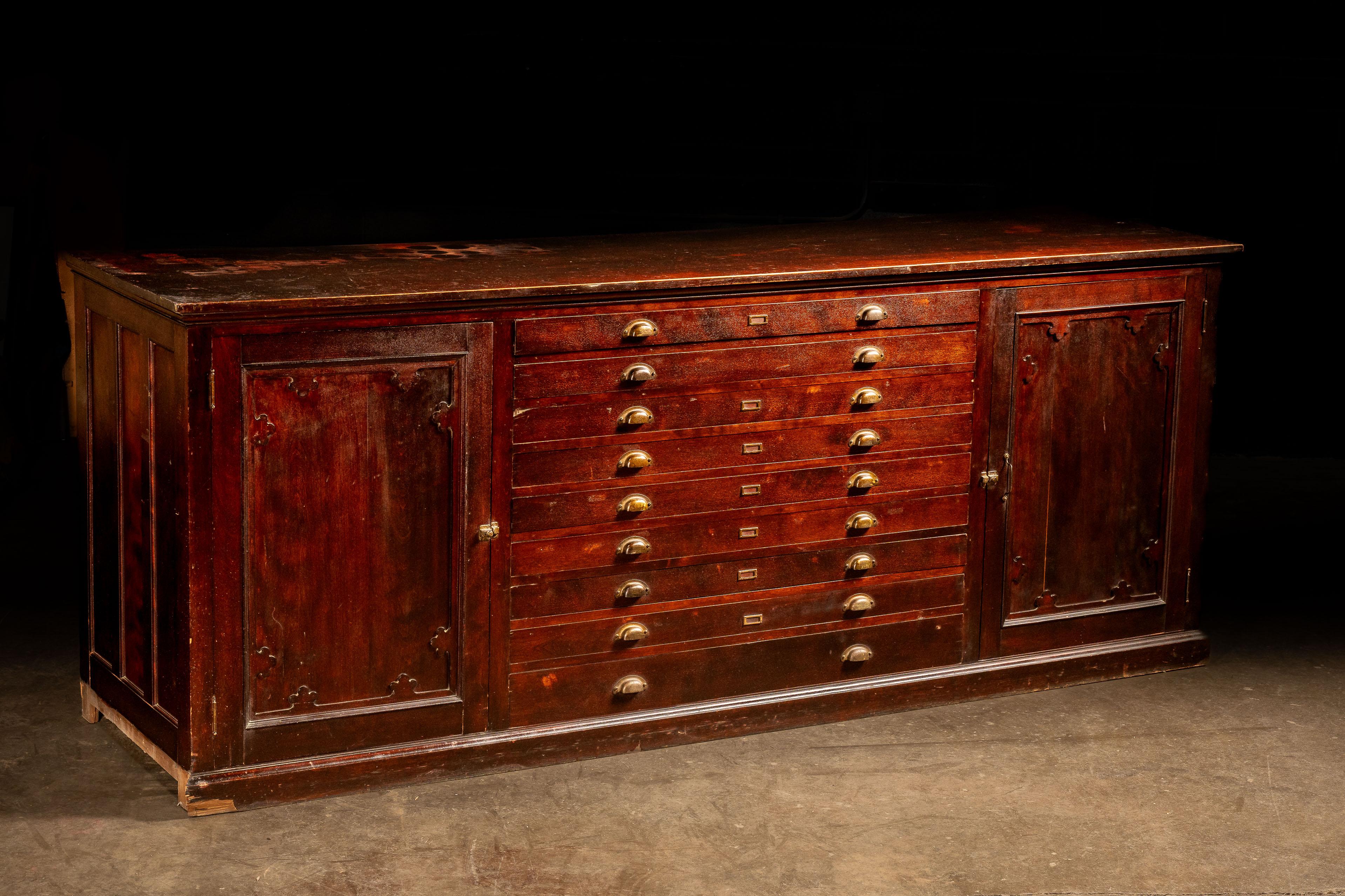 c. 1940s

Vintage hardwood flat file cabinet with additional hideaway shelving.

This impressive piece offers the same options as typical flat file cabinets, plus a little extra. In addition to nine traditional flat file drawers, the paneled
