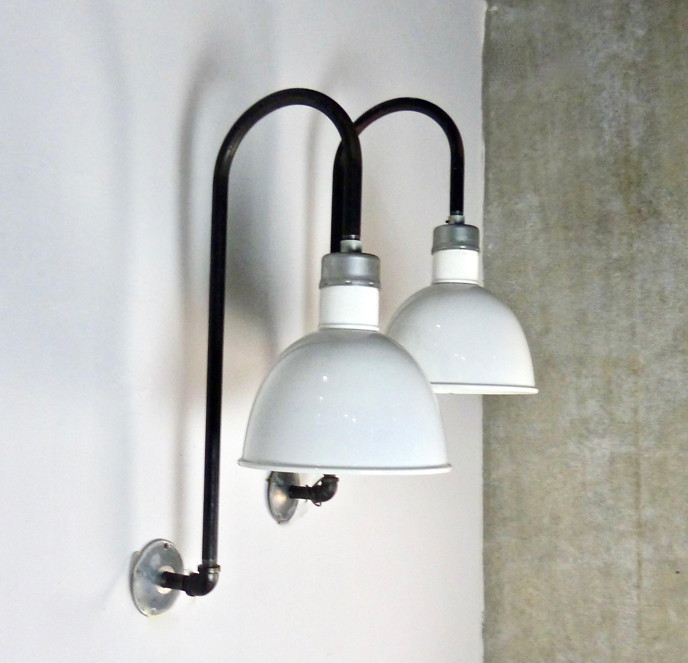 Matched pair of industrial wall sconces. White enamel shades mounted on pipe. Re-wired and CSA approved to current electrical standards. Nice size and character. Price per light.
Dimensions 28” H x 16” W x 16” D”.