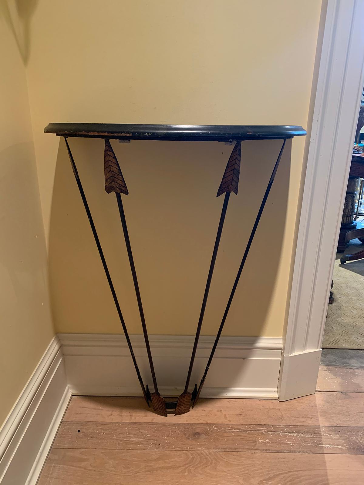 20th century circa 1940s Art Deco style demilune wall mount iron console with gilt metal arrows and faux marbleized wood top.