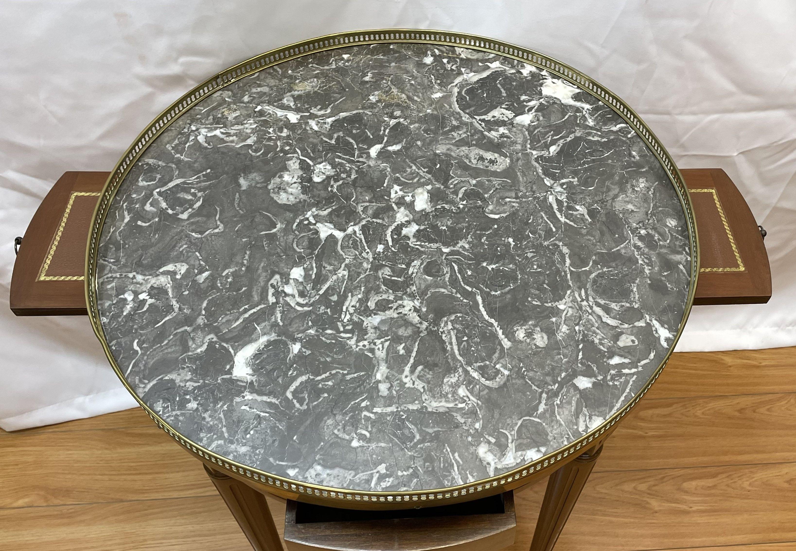 Circa 1940's Bouillotte marble top table with pullout tooled leather glass holders and brass reticulated surround 